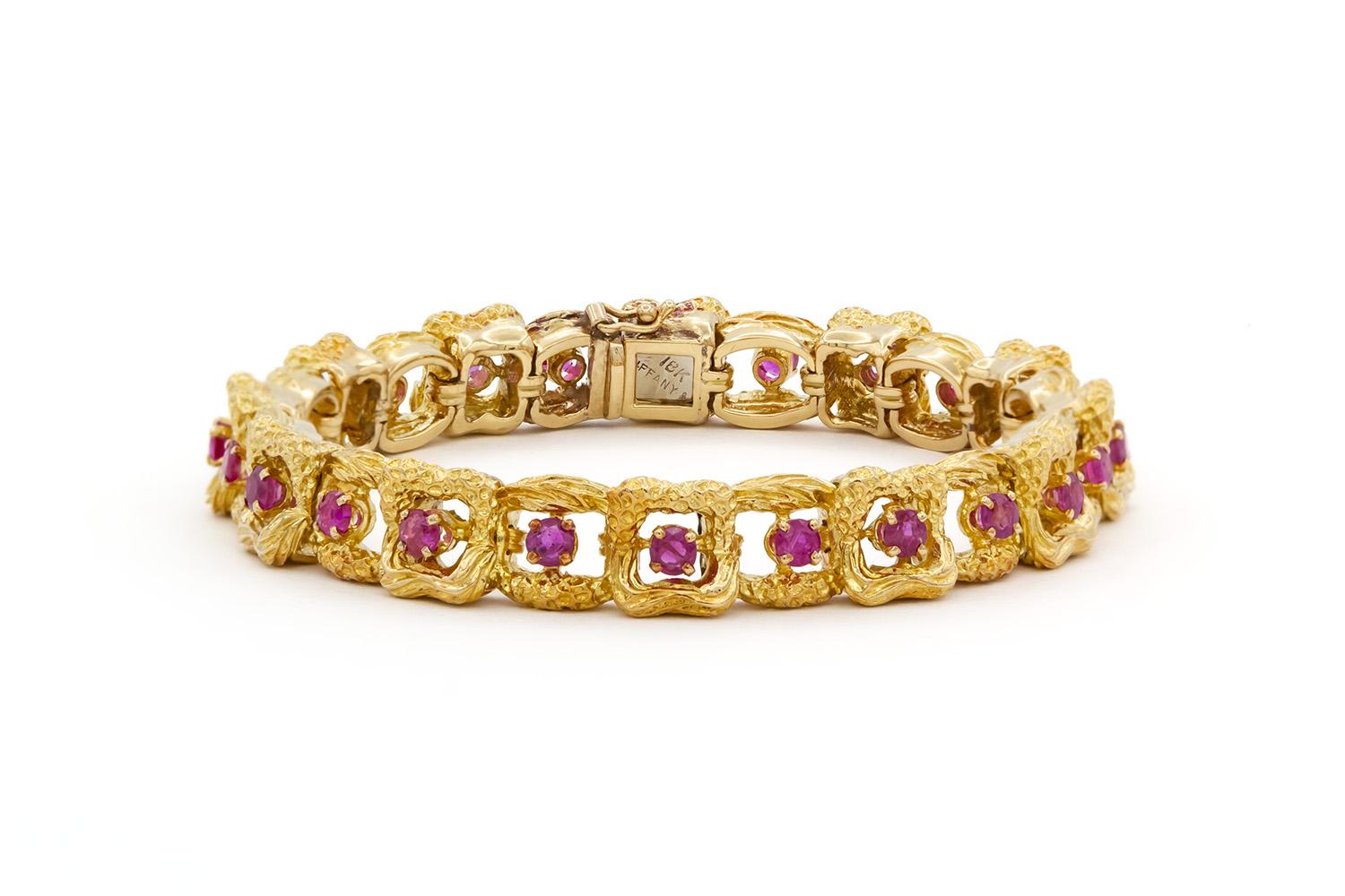 We are pleased to offer this Vintage Tiffany & Co. 18k Yellow Gold & Ruby Link Bracelet. In classic Tiffany style this bracelet is finely crafted from 18k yellow gold and features 24 round single cut rubies estimated at 2.75ctw. Unique and elegant,