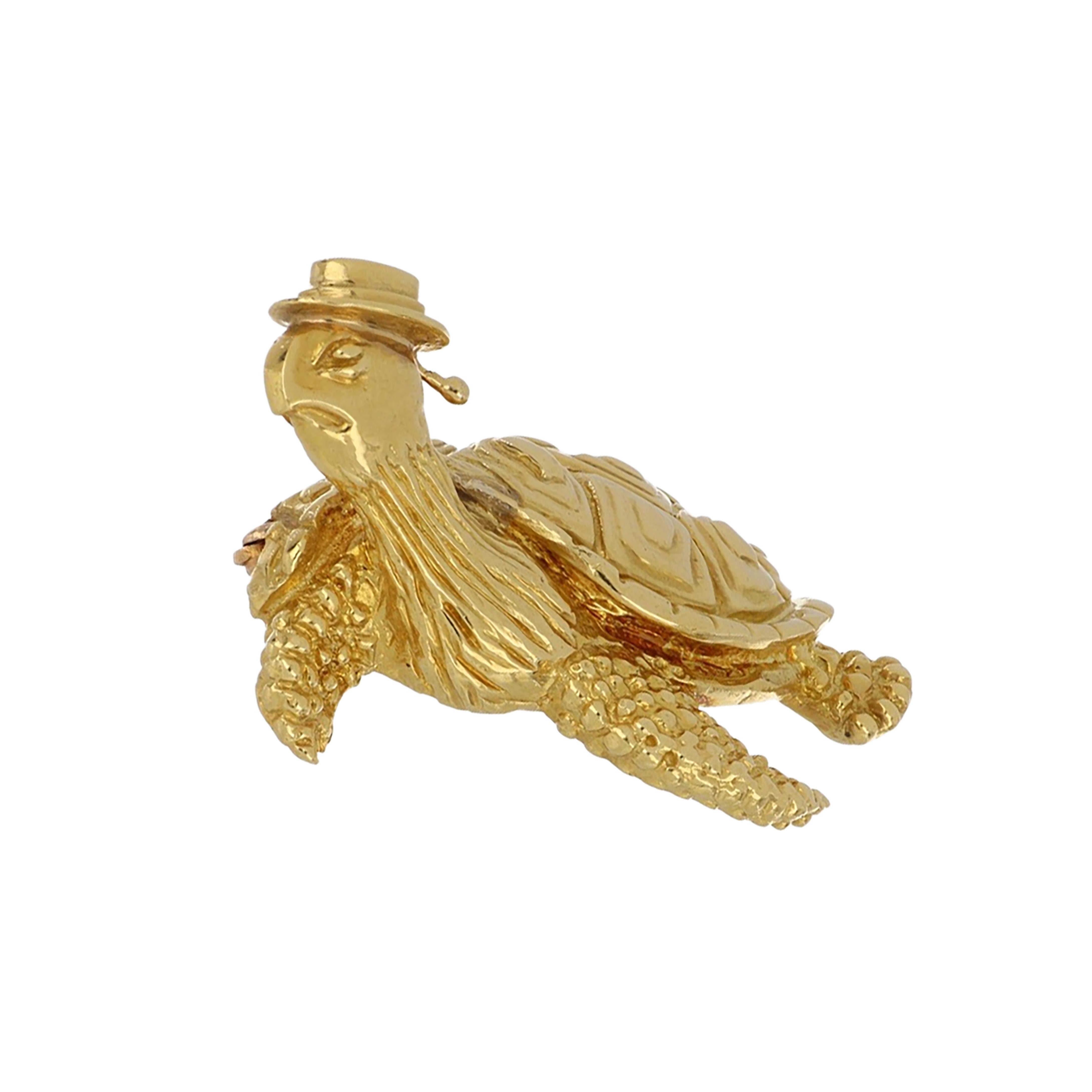 Vintage Tiffany & Co. 18K yellow gold sea turtle pin with a hat and textured gold detail. 