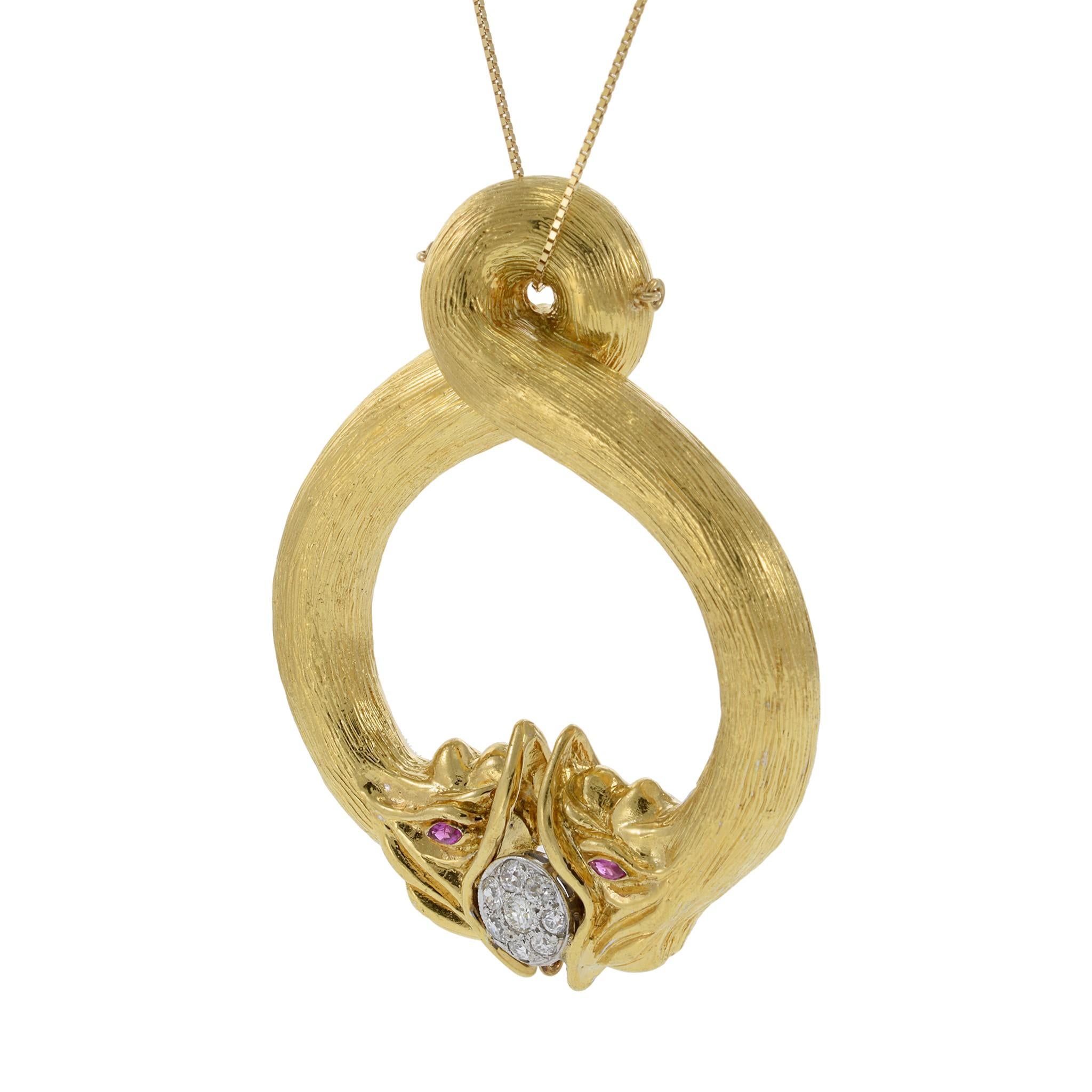 This exceptional vintage pendant from Tiffany & Co. showcases a striking double snake design in 18KT yellow gold, weighing 53.1 grams. The piece is adorned with 0.65CT total weight of old European cut diamonds, graded F-VS, and accented with vibrant