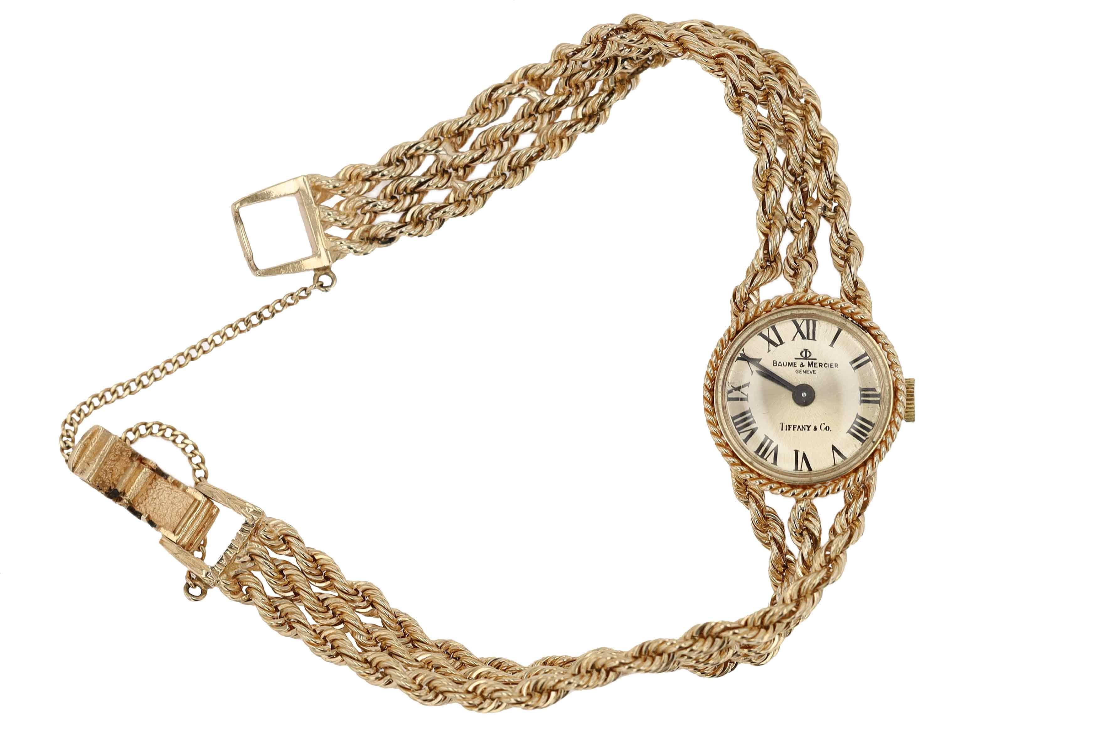 Boasting a minimalist design, this delightful 1970s Tiffany & Co. cocktail / dress watch is the quintessential accessory for any vintage fashionista. The classy 14 karat yellow gold, solid 3 strand rope bracelet offers a luxurious statement from all
