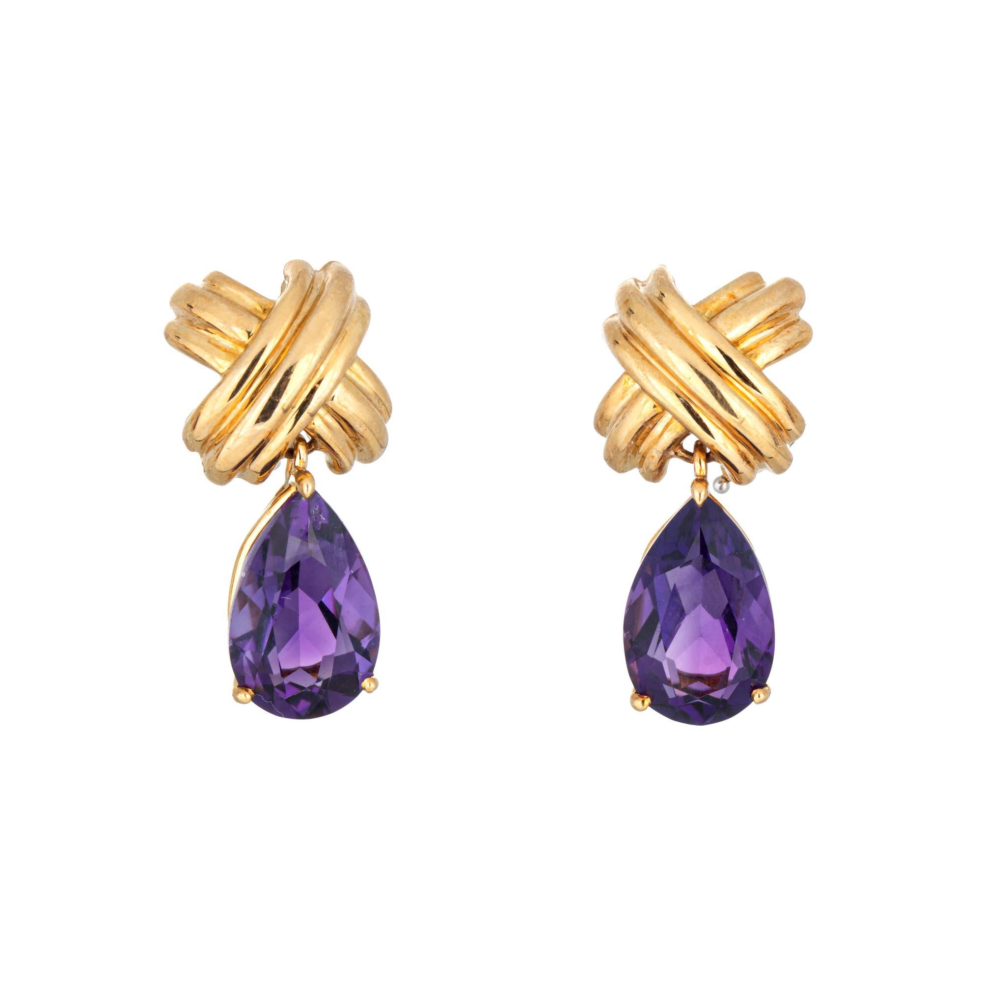 Stylish and finely detailed vintage amethyst Tiffany & Co 'X' cross signature earrings, crafted in 18 karat yellow gold.  

Pear cut amethysts measure 13mm x 8mm. The amethysts are in very good condition and free of cracks or chips.

The signature
