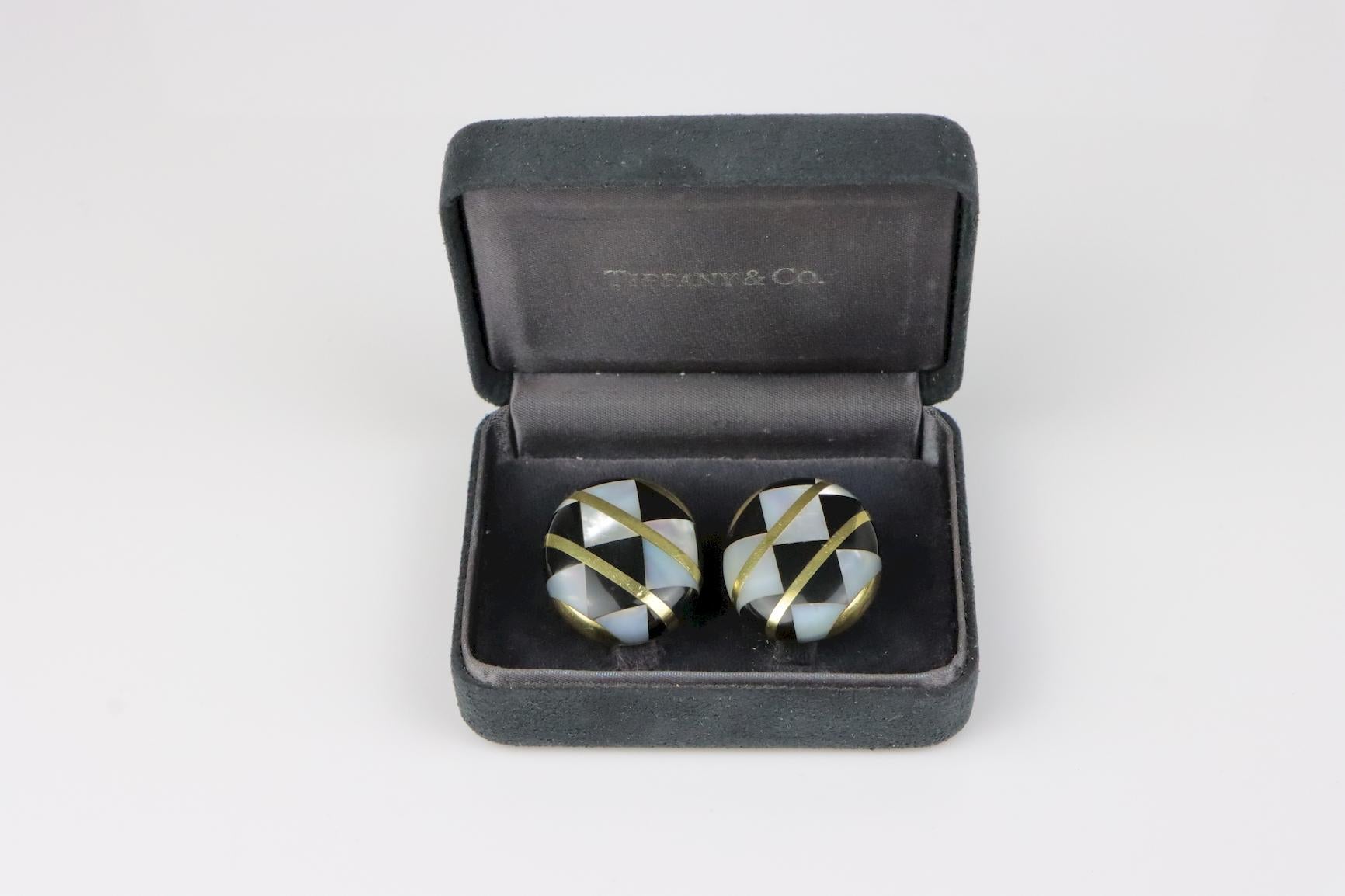 Vintage Tiffany & Co. Angela Cummings 18K Gold Earrings  - Large Model 
Large model example

Materials:
Solid 18K Gold, Mother of Pearl & Onyx Inlay

Approximate Dimensions:
3 cm (Length) x 2.5 cm (Width) x 9.30 mm (Thickness) 
28 grams in weight