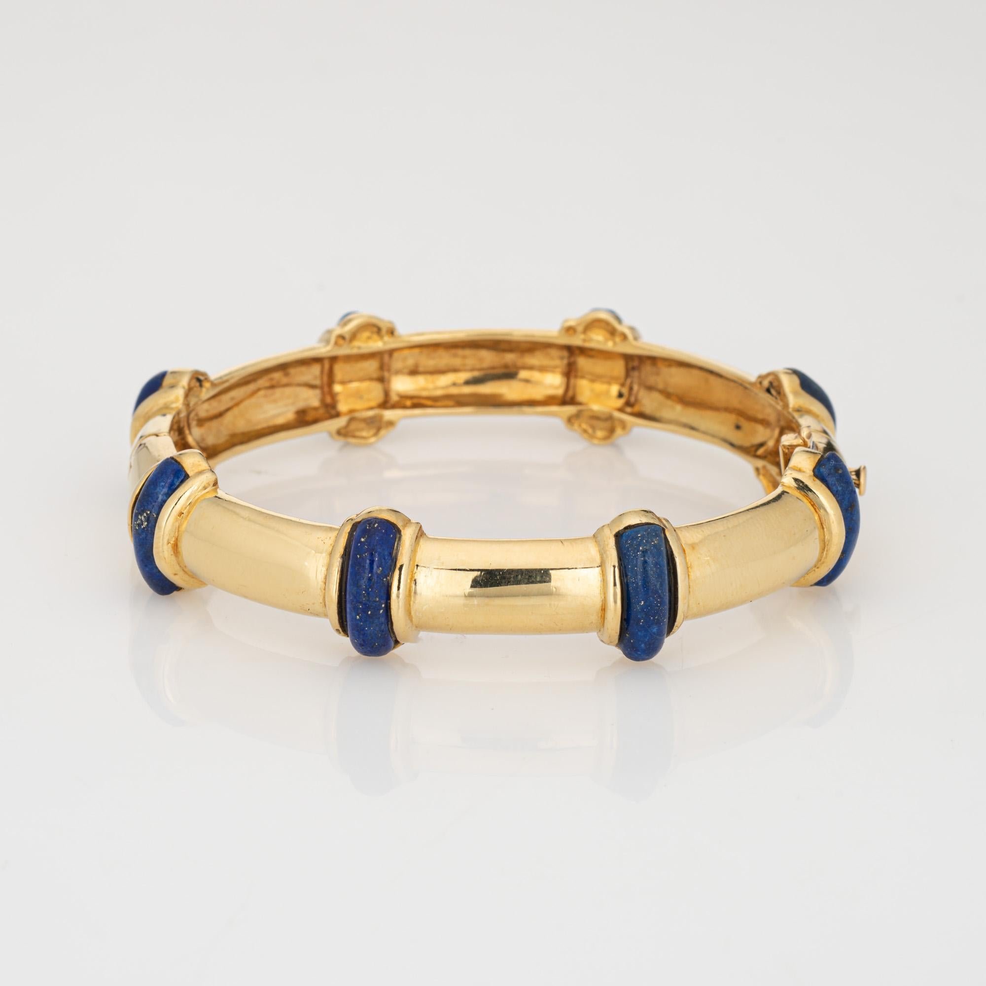 Stylish and finely detailed vintage Tiffany & Co lapis lazuli bangle bracelet, crafted in 18 karat yellow gold.

Lapis lazuli cabochons measure 12mm x 4mm. The lapis is in very good condition and free of cracks or chips.
The bracelet features lapis