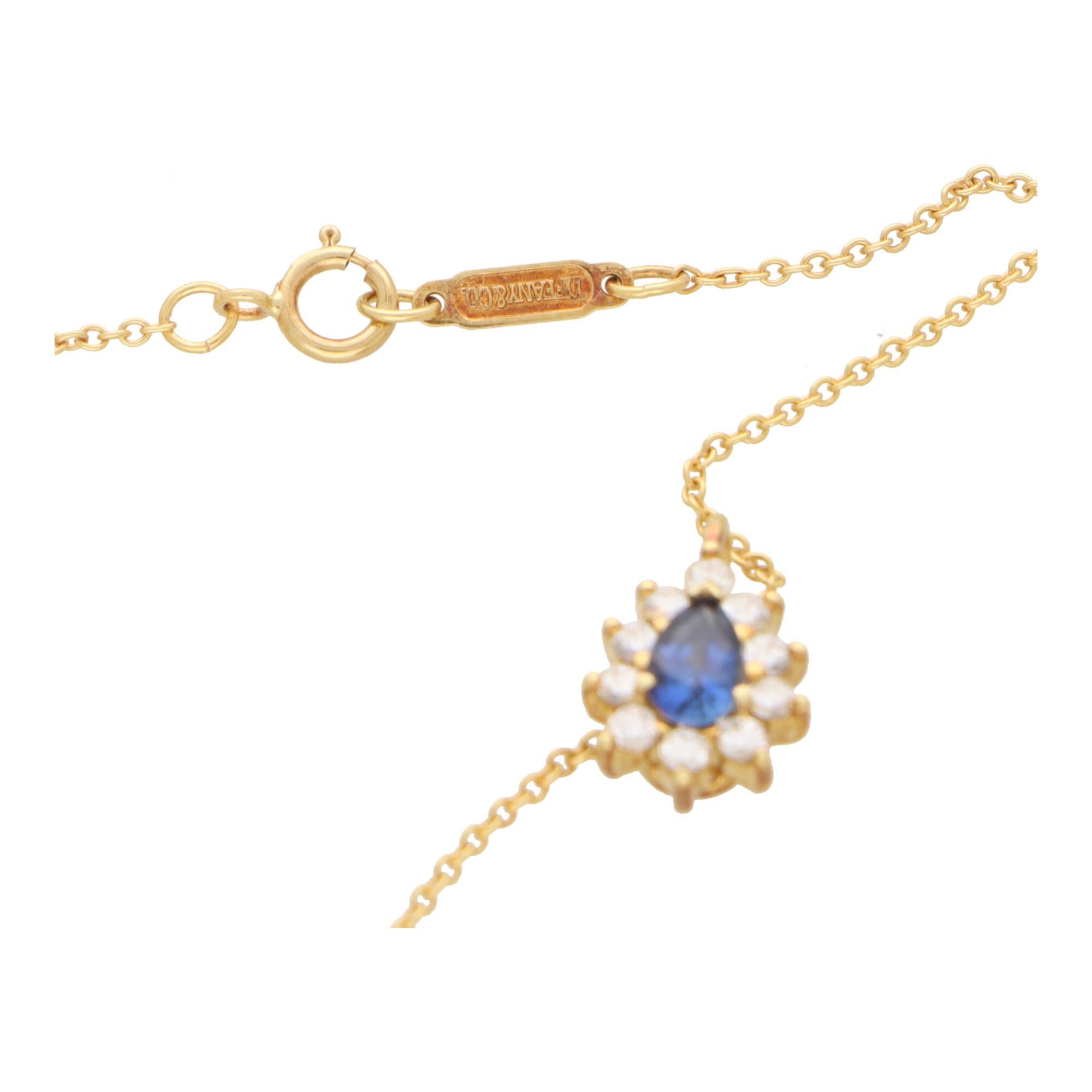 
A beautiful vintage Tiffany & Co. sapphire and diamond cluster pendant necklace set in 18k yellow gold.

The pendant is firstly composed of a pear cut blue sapphire which is surrounded by a cluster of 10 round brilliant cut diamonds. The pendant