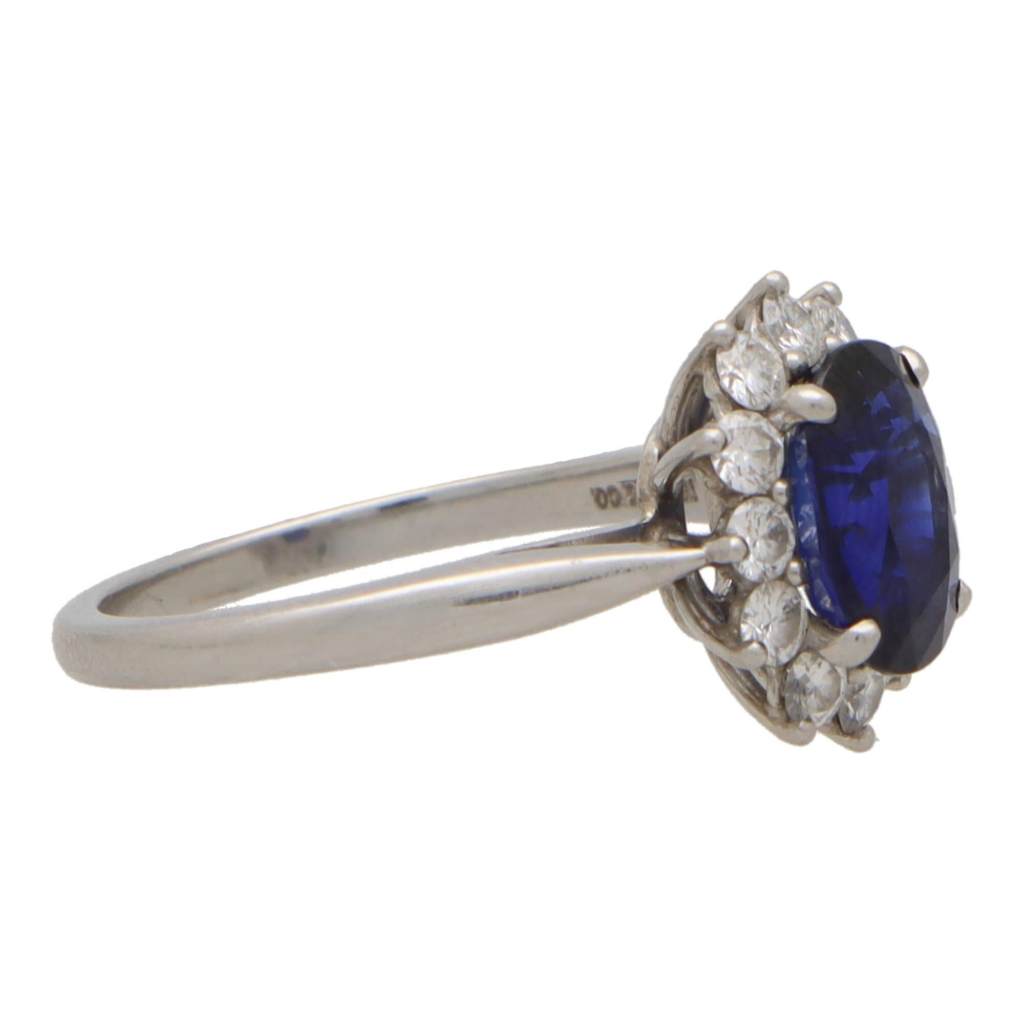 A beautiful vintage Tiffany & Co. sapphire and diamond cluster ring set in platinum.

The piece is centrally set with a vibrant oval cut sapphire which is four-claw set securely. The sapphire has a fantastic blue colour to it and is surrounded by a