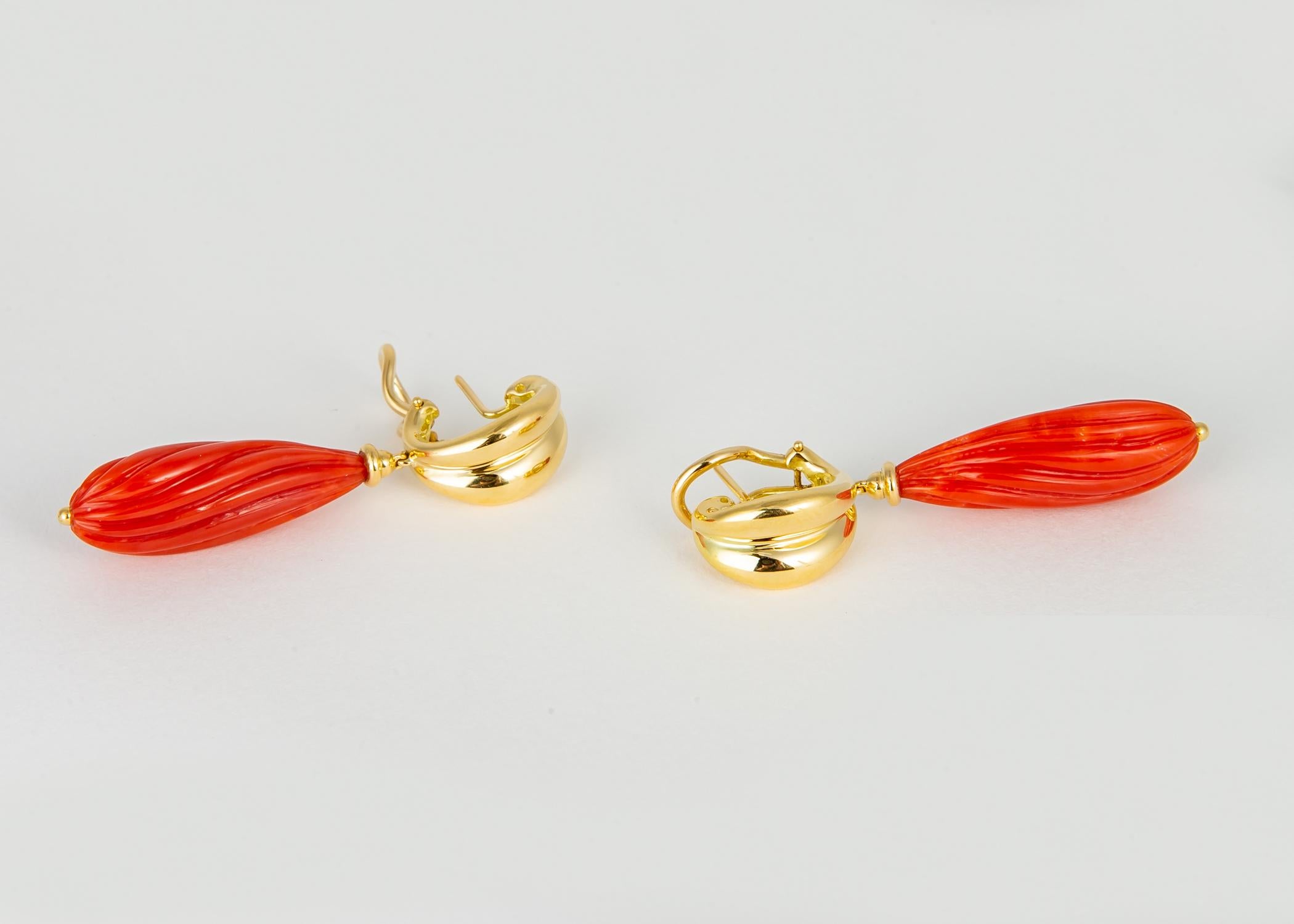 A truly collectable pair of vintage Tiffany & Co. earrings.  Deep orange mediterranean coral is beautifully carved and suspended from rich 18k gold. Simply elegant !!! 1 3/4 inches in length.