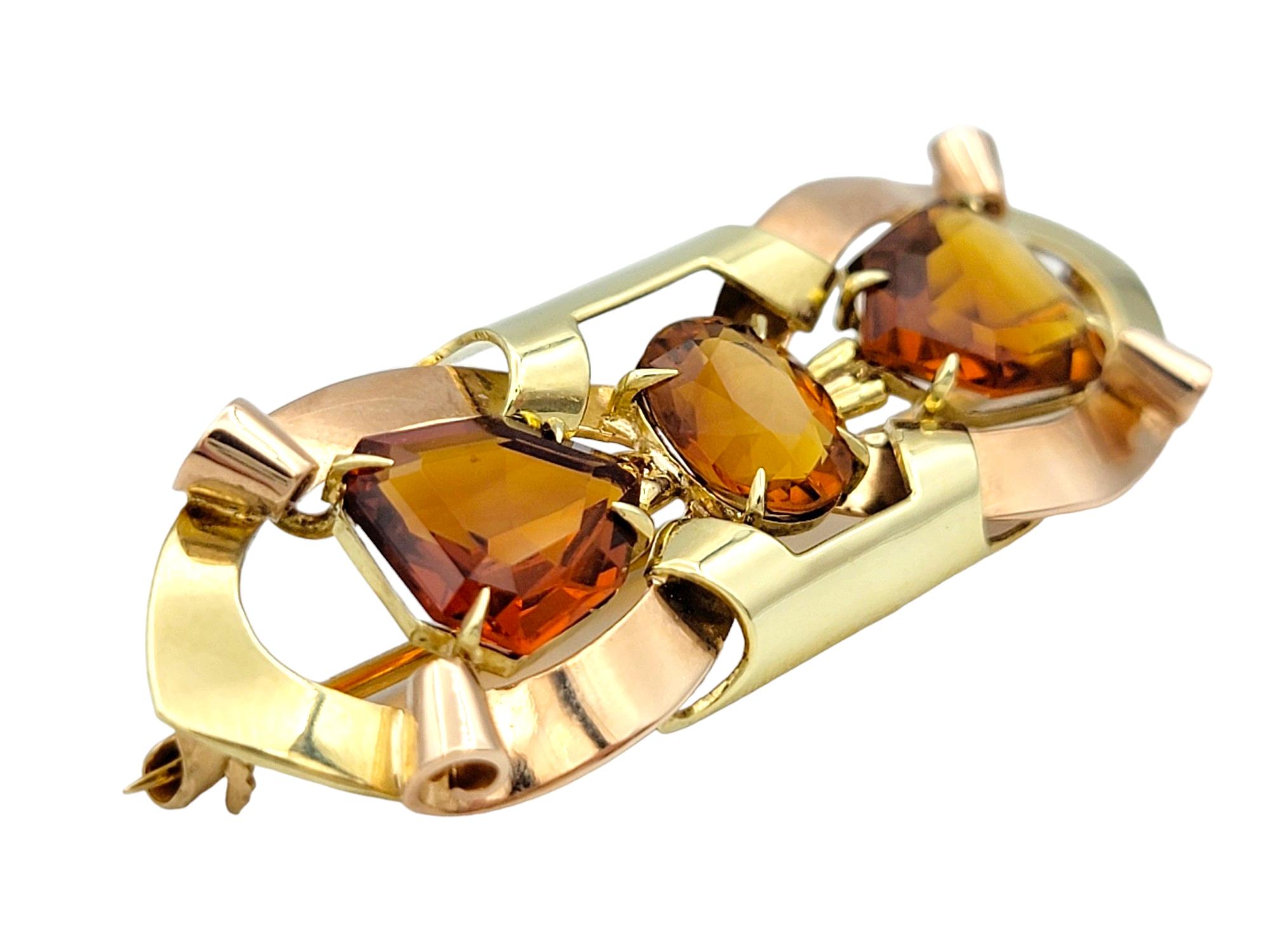 This gorgeous Tiffany & Co. vintage ribbon design brooch exudes classic elegance and timeless charm. Crafted from luxurious 14 karat yellow and rose gold, this exquisite piece features a beautifully detailed ribbon motif adorned with vibrant citrine