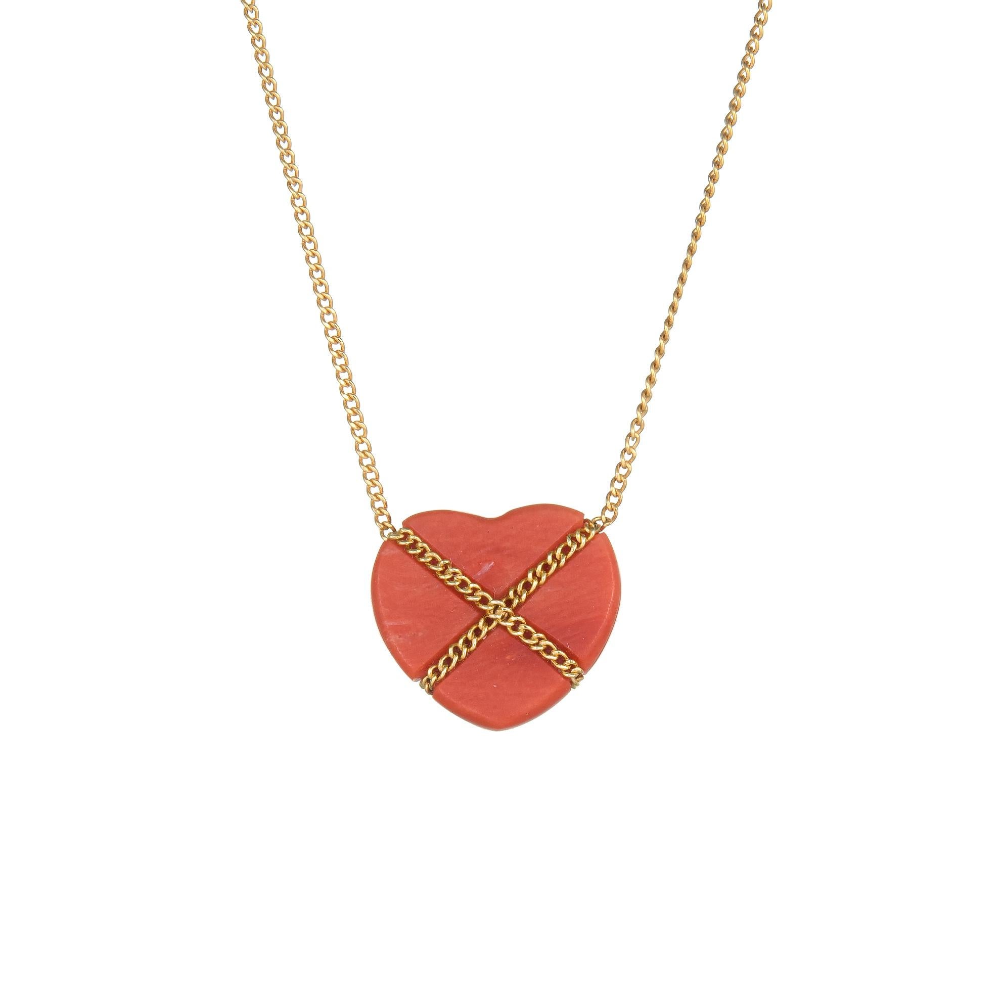 Elegant and finely detailed vintage Tiffany & Co coral Cross My Heart necklace, crafted in 18 karat yellow gold.  

Coral is set into the necklace and measures 14mm x 13mm. The coral is in excellent condition and free of cracks or chips. 

The