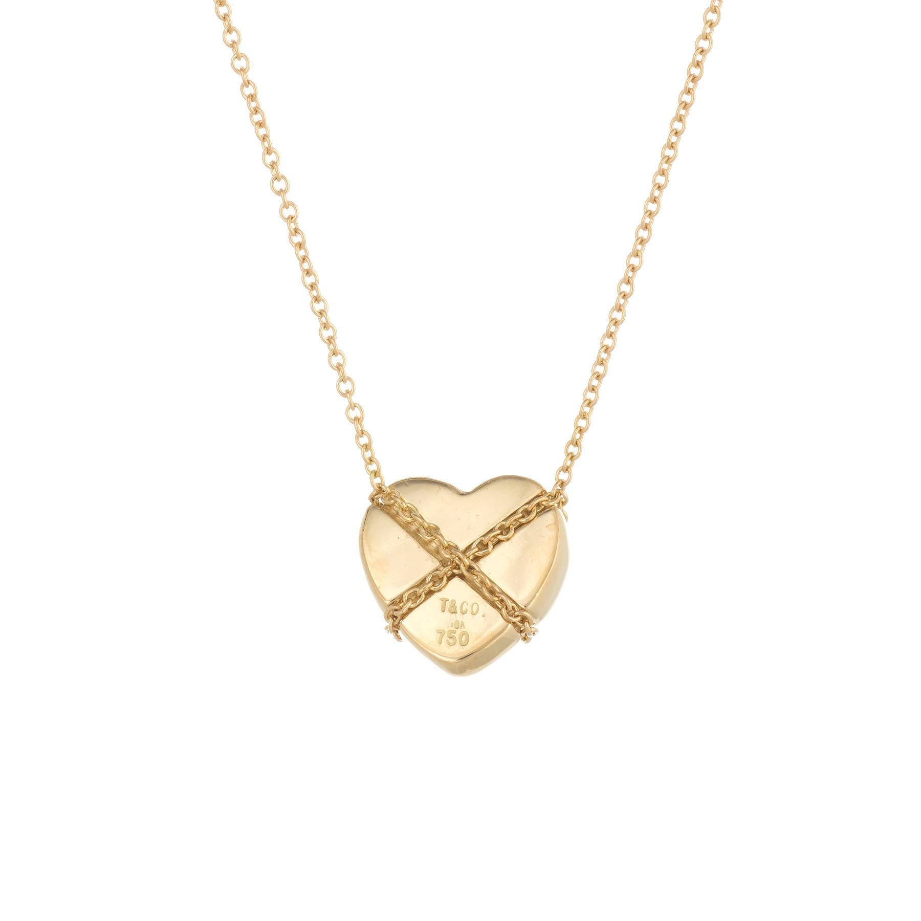 Elegant and finely detailed vintage Tiffany & Co Cross My Heart necklace, crafted in 18 karat yellow gold.  

The necklace is a retired piece and no longer made by Tiffany & Co.

The necklace is in excellent original condition.