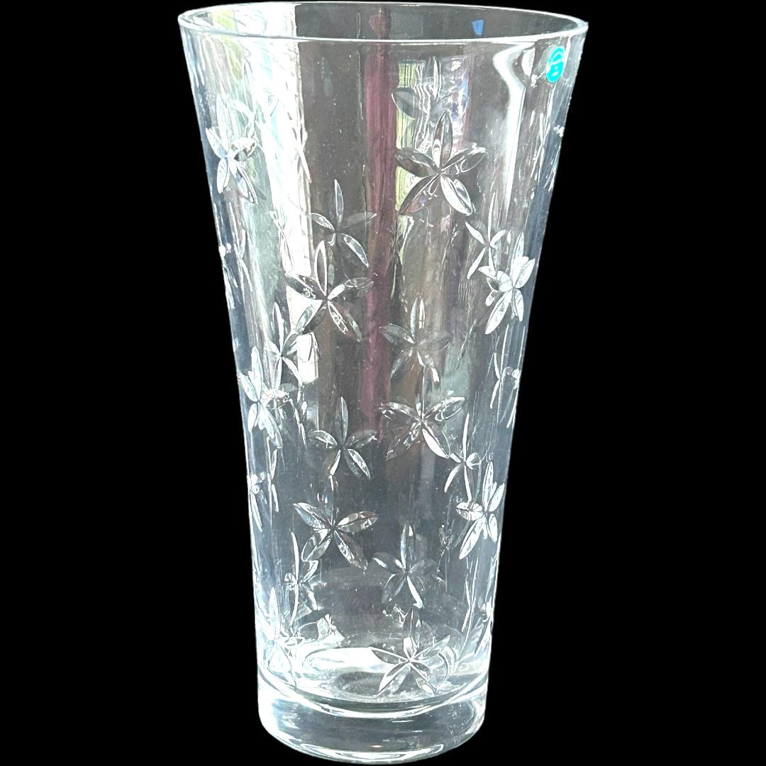 This vintage Tiffany & Co. vase features a beautiful star flower pattern made of cut crystal.  The circular shape stands at 12” tall and 6.25” width.  Perfect for any occasion, this clear vase is a stunning addition to any decor.  Made in Italy,