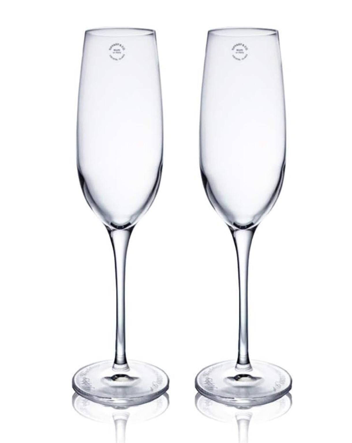 Elevate your next toast with these vintage Tiffany & Co. champagne flutes, made from high-quality crystal.  The clear glass design allows the bubbles to shine through, creating a beautiful visual effect.  They come with an iconic blue Tiffany & Co.