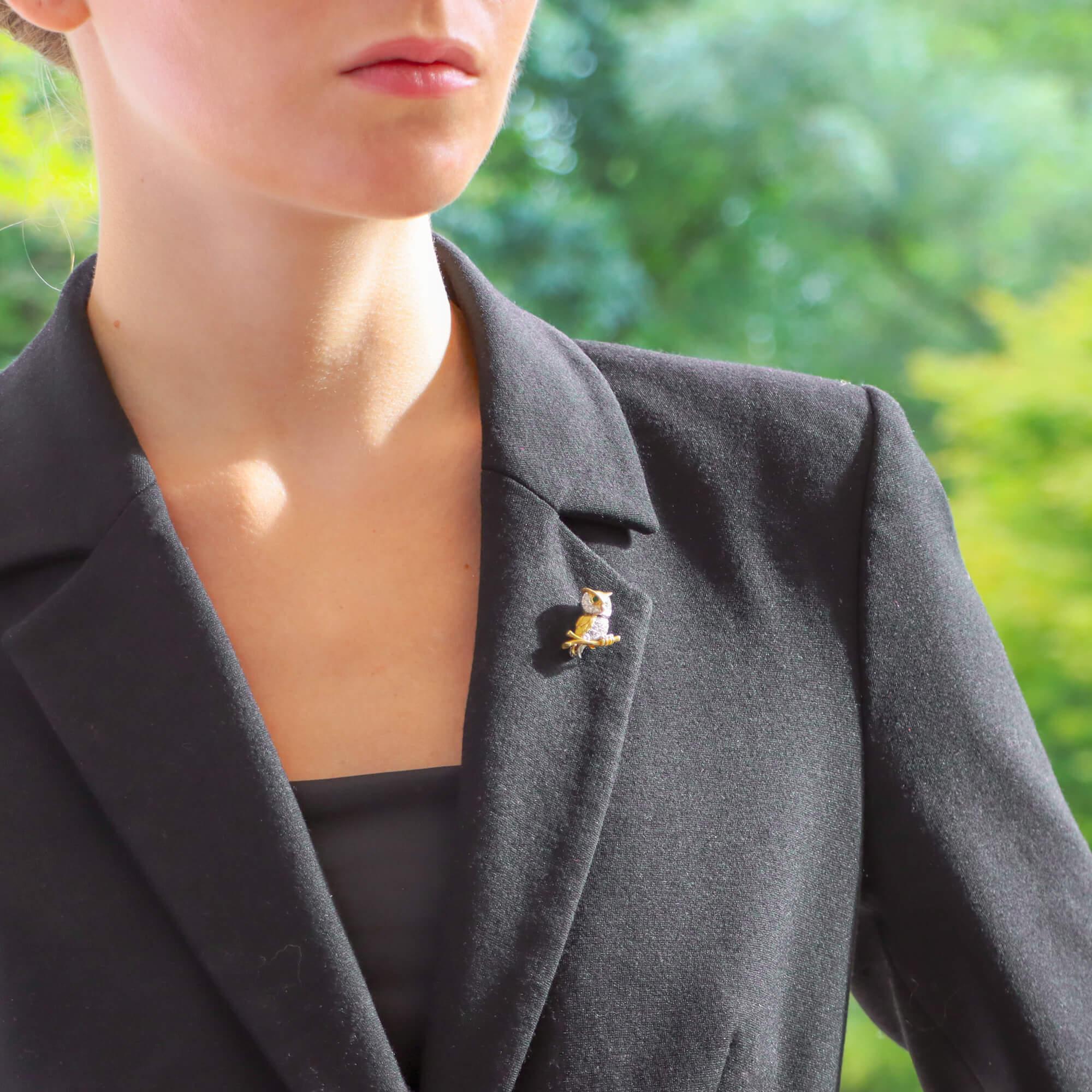  A beautiful vintage Tiffany & Co. diamond and emerald perching owl brooch set in 18k yellow gold.

The brooch depicts a lovely perching owl who is sat upright on a textured yellow gold branch. The owl has been beautifully hand crafted and cleverly
