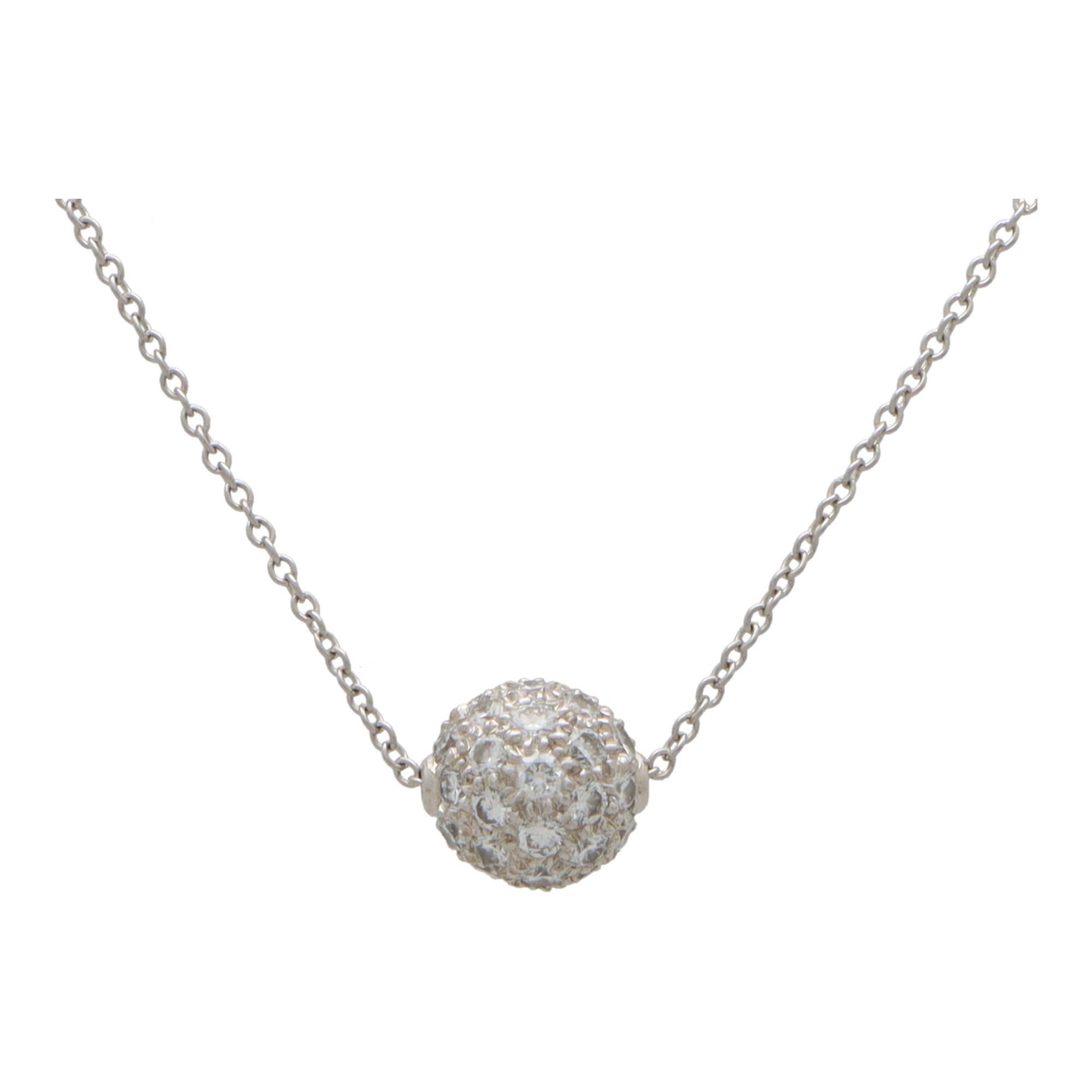 A beautiful vintage Tiffany & Co. diamond ball necklace set in platinum. 

The pendant is composed of a solid platinum ball which is completely pave set with 42 round brilliant cut diamonds. The ball hangs from a 16-inch Tiffany platinum trace