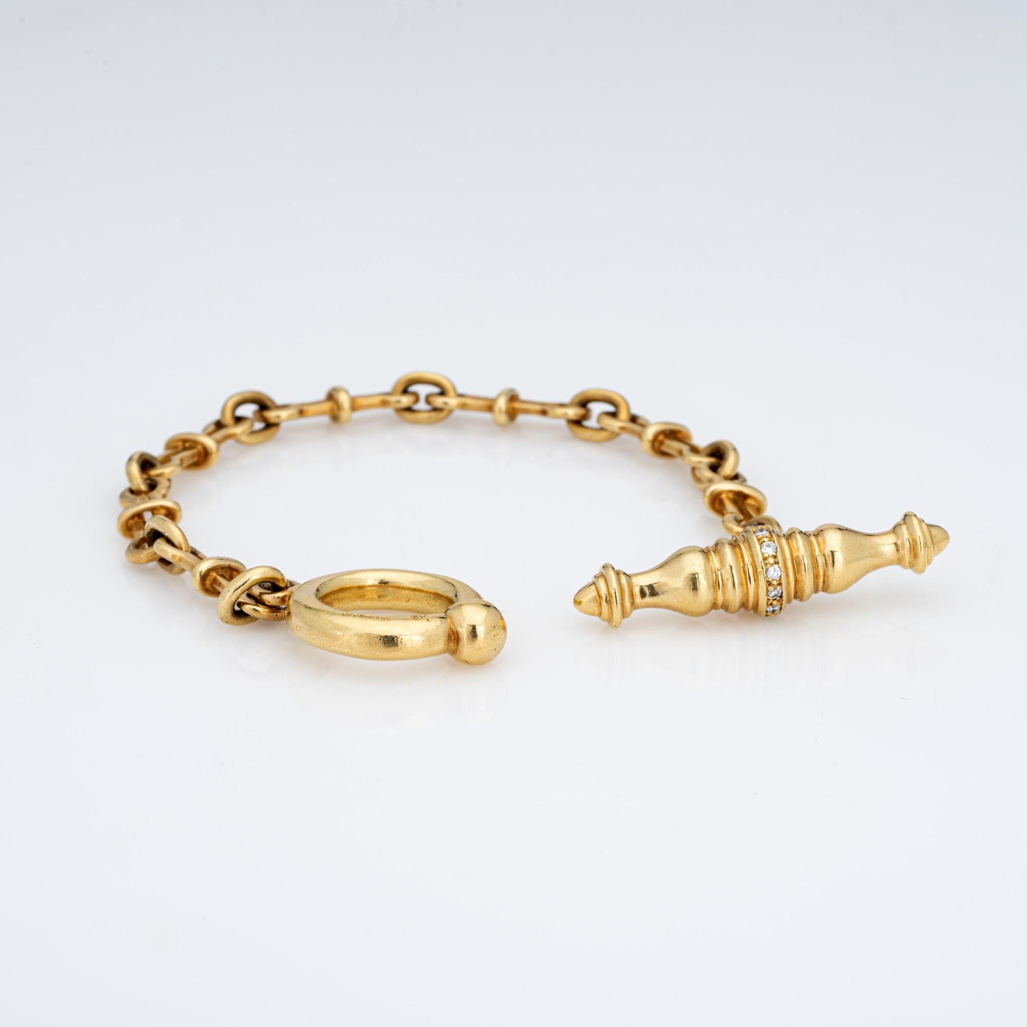 Stylish vintage Tiffany & Co diamond bracelet crafted in 18 karat yellow gold.  

11 round brilliant cut diamonds total an estimated 0.11 carats (estimated at H-I color and VS2 clarity). The intricate links terminate to a diamond set bar and toggle