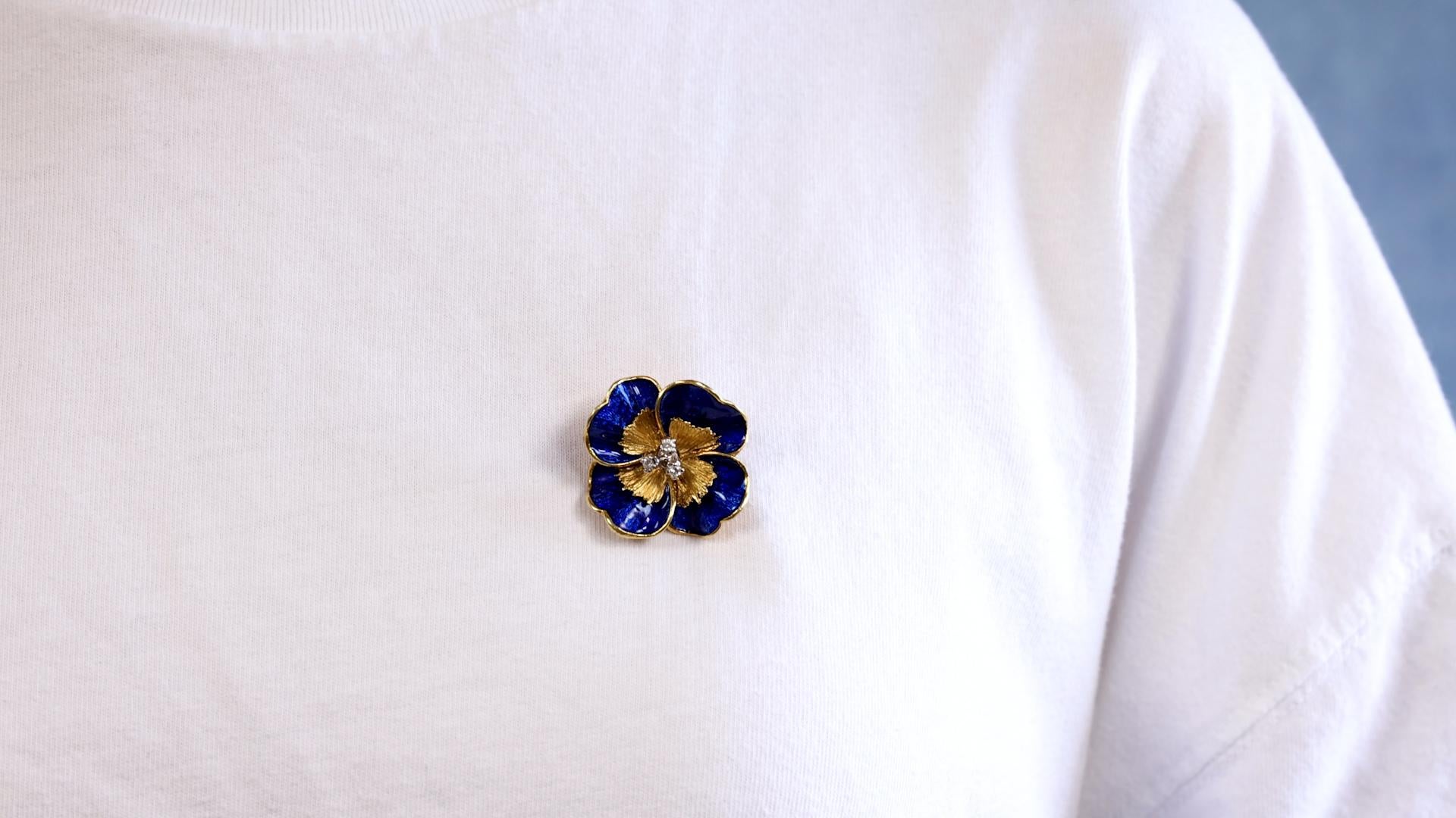 One Vintage Tiffany & Co. Diamond Enamel 18k Yellow Gold Pansy Brooch. Featuring three round brilliant cut diamonds with a total weight of approximately 0.20 carat, graded F color, VS clarity. Crafted in 18 karat yellow gold and blue enamel signed