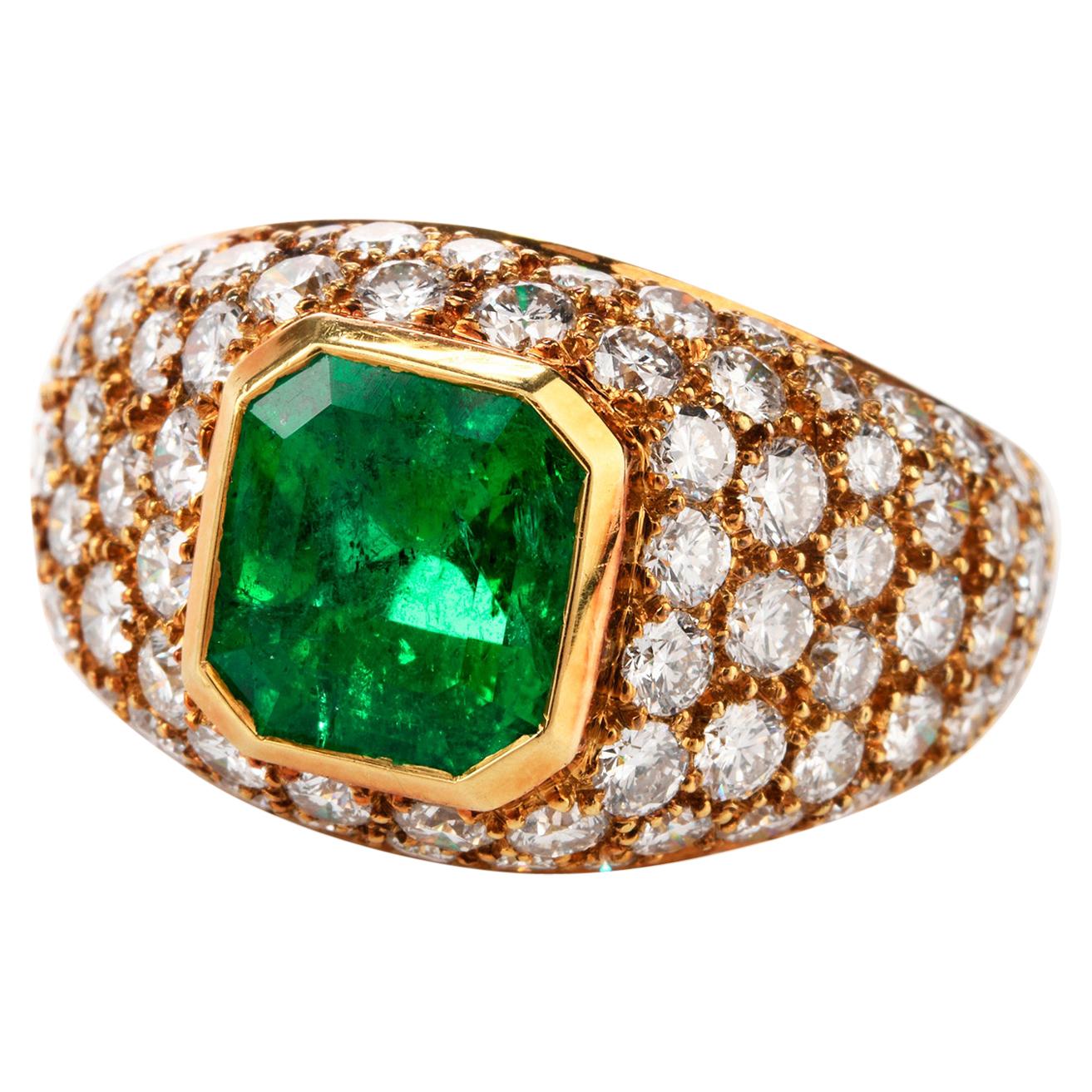 This alluring Tiffany and Co ring has many focal points of interest and was crafted in 18K Yellow Gold. Featuring an Asscher cut GIA certified Colombian Emerald in the center weighing approx. 2.18 carats,  this domed ring has pave set Diamonds