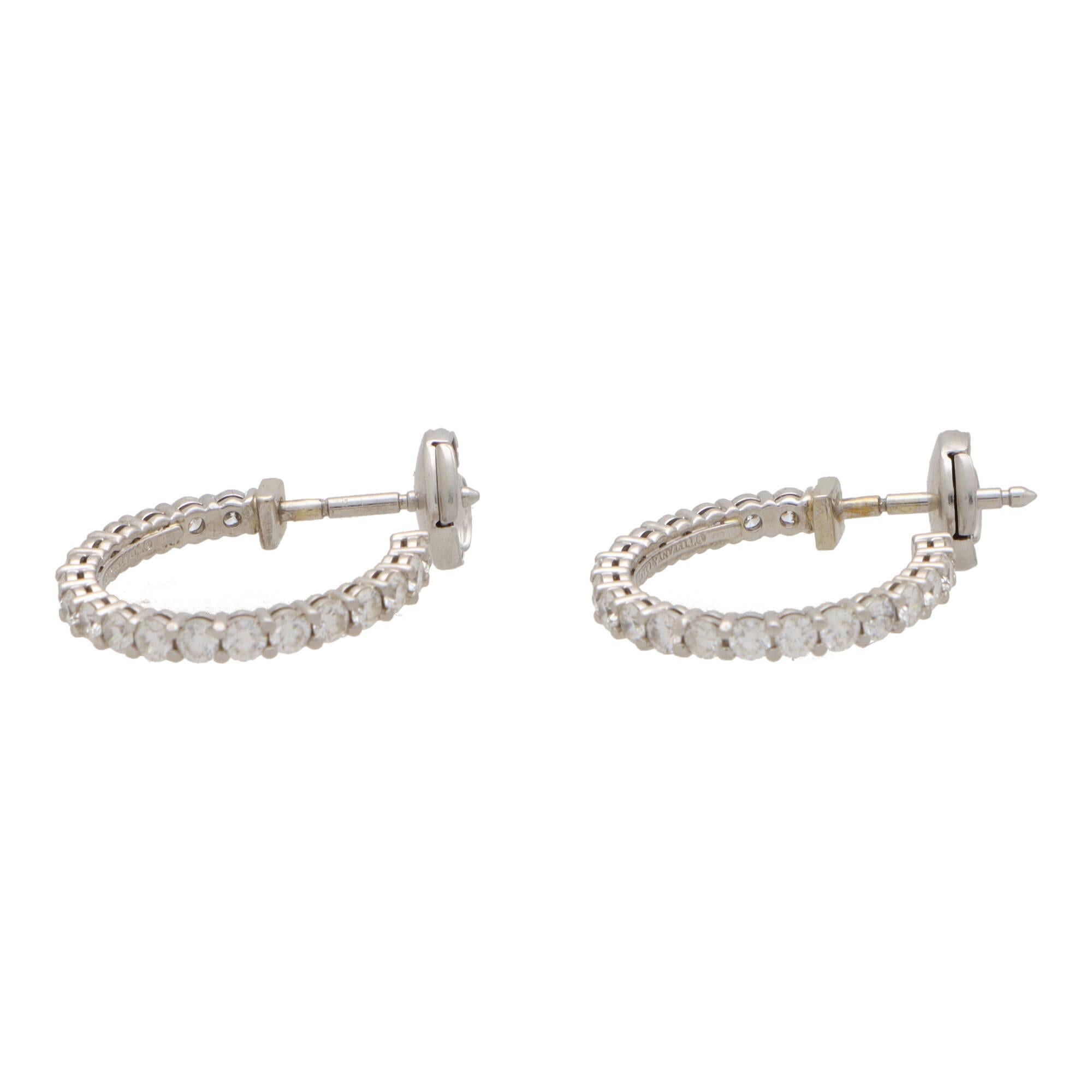 A beautiful pair of vintage Tiffany & Co. diamond hoop earrings set in platinum.

Each earring is composed of an elegant claw set hoop, set throughout with 20 round brilliant cut diamonds. They are secured to reverse with a post and alpha back