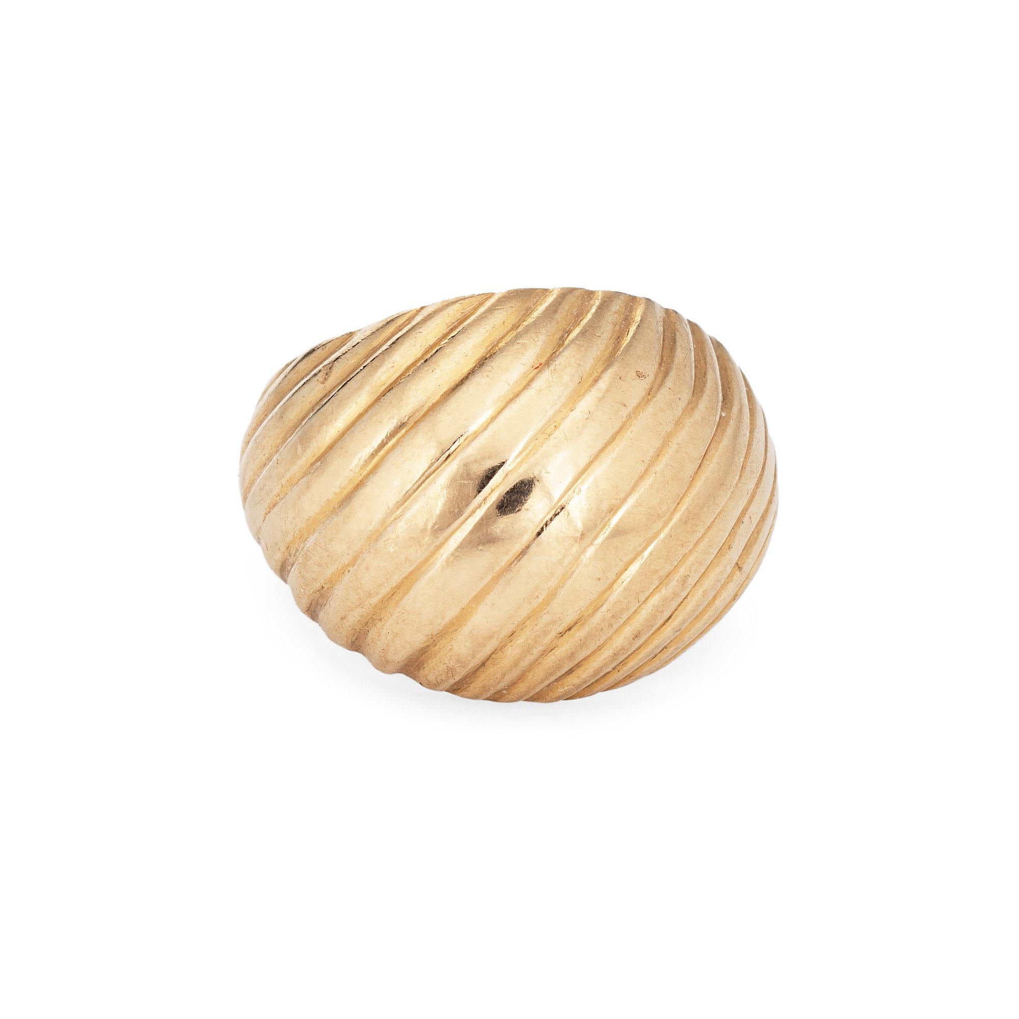 Vintage Tiffany & Co dome ring crafted in 14 karat yellow gold (circa 1950s to 1960s).  

The mid century domed ring features an off-center textured ribbed design. The mid-rise dome rises 6.5mm from the finger (0.25 inches). Currently a size 4 1/2