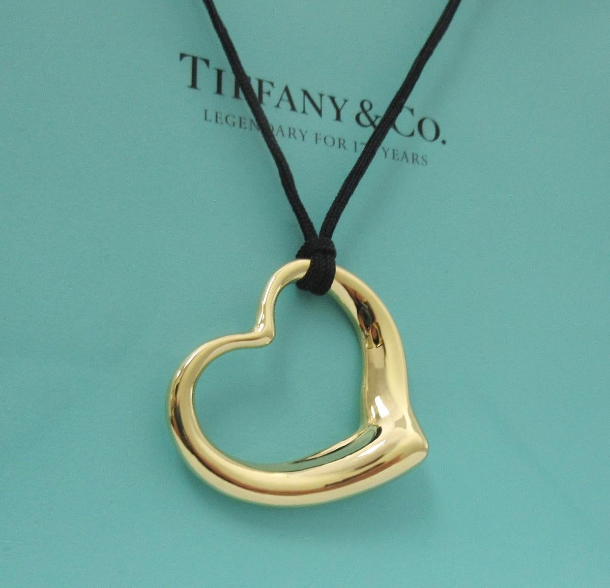 Vintage TIFFANY & Co. Elsa Peretti 18K Gold 36mm Open Heart Pendant Necklace

Metal: 18K Yellow Gold
Gold Weight: 11.20 grams
Pendant: 36mm wide 
Silk cord: 16