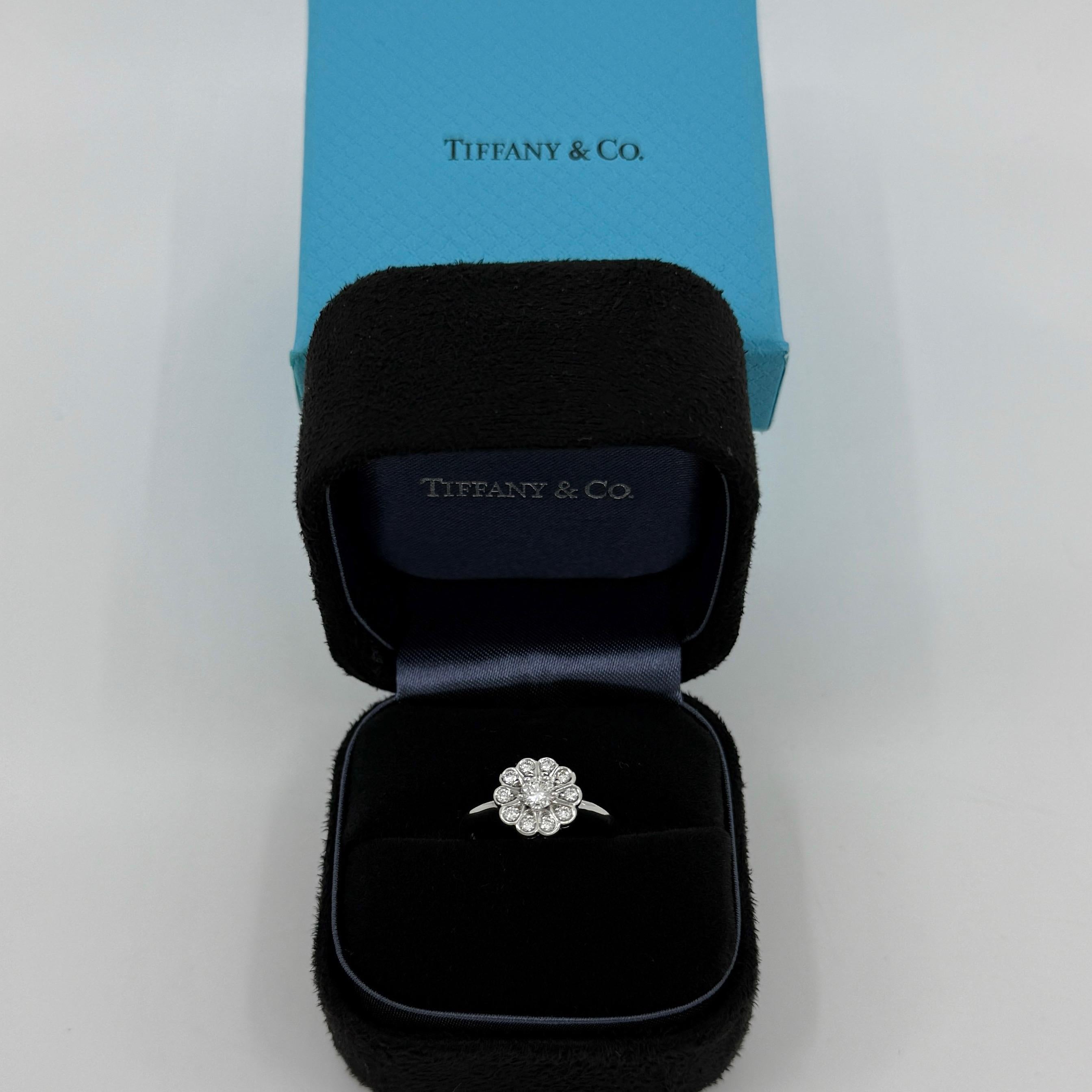Vintage Tiffany & Co. Enchanted Flower Natural Diamond 950 Platinum Halo Ring.

A beautiful platinum cluster ring set with a 3.7mm round brilliant cut centre diamond and a halo of 1.7mm accents. Superb colour, clarity and cut on these. VS clarity