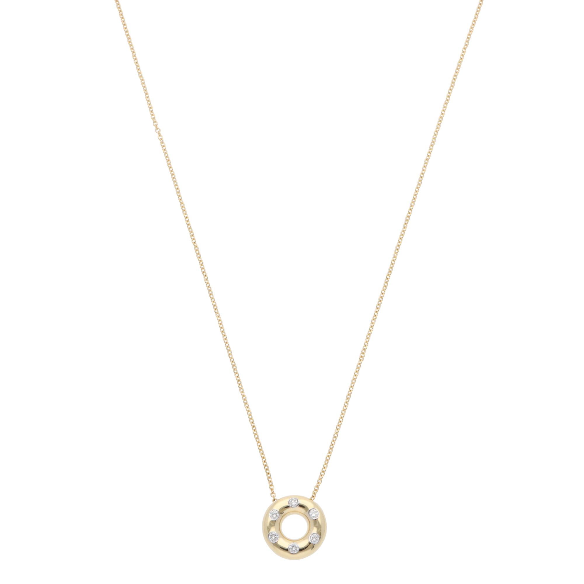 A beautiful vintage Tiffany & Co. Etoile diamond pendant necklace in platinum and 18k yellow gold.

From the discontinued Etoile collection, the pendant depicts a polished yellow gold doughnut set with 6 round brilliant-cut diamonds. Each diamond is