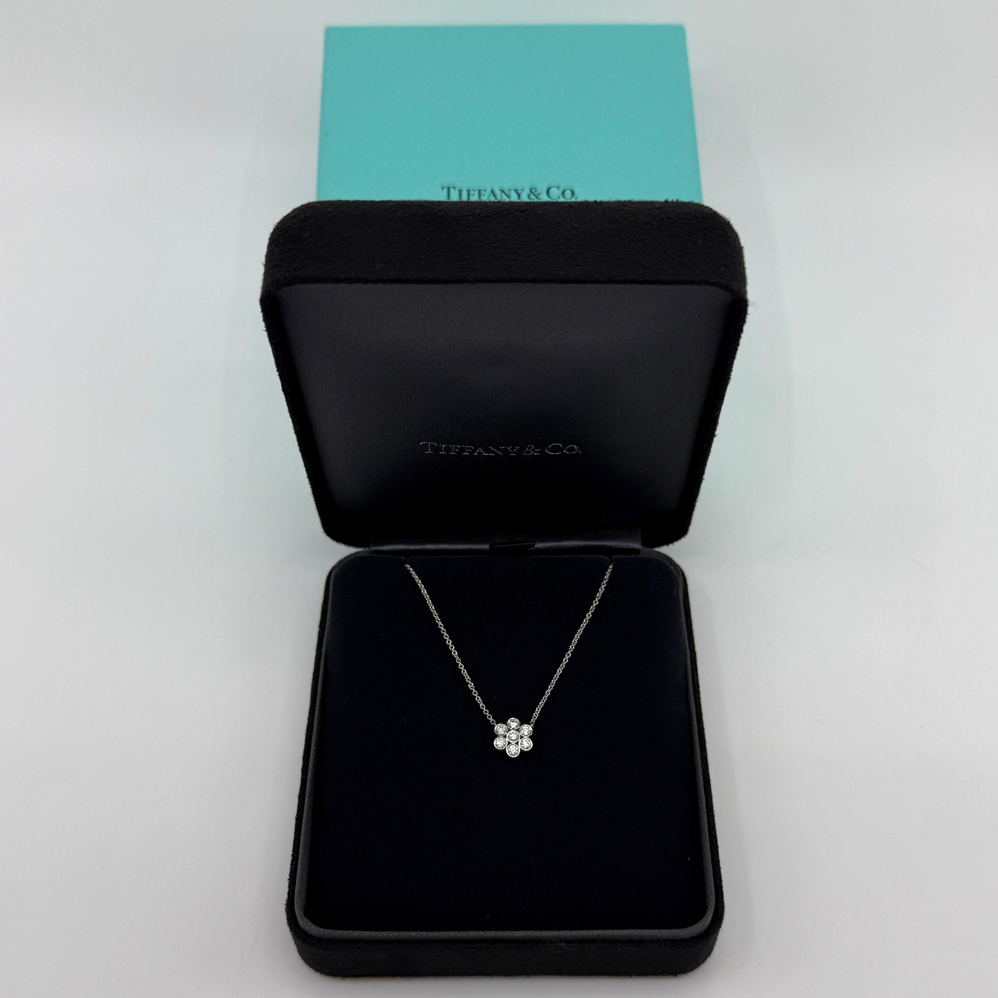 Vintage Tiffany & Co. Flower Garden Round Cut Diamond 950 Platinum Pendant Necklace.

A beautiful platinum pendant necklace set with a beautiful arrangement of natural round brilliant cut white diamonds measuring approx. 3mm each in bezel.
These are