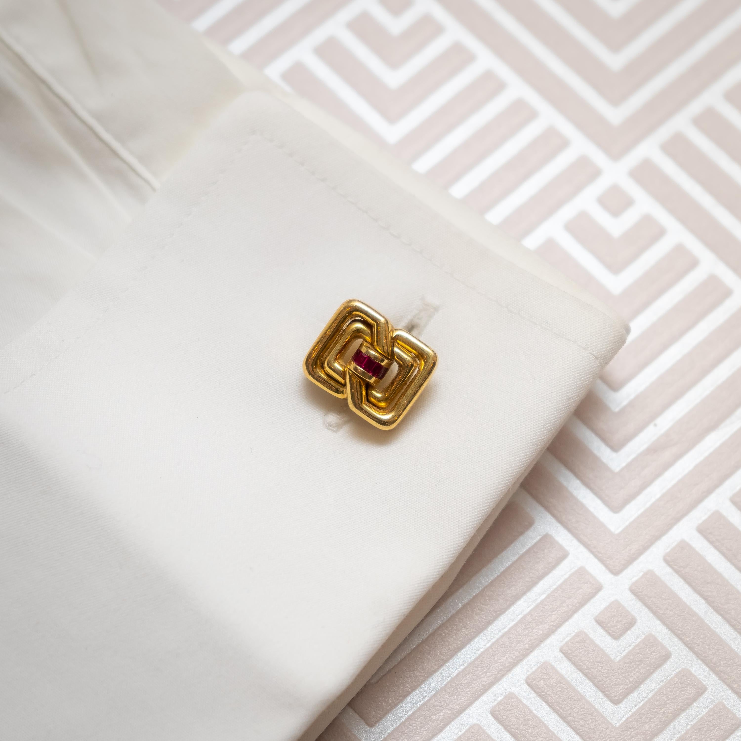 A pair of vintage Tiffany & Co. ruby and gold cufflinks, with a geometric, double figure-of-eight design, with baguette-cut rubies in the centre, in channel settings, mounted in 18ct gold, with bars and tilting terminals, signed Tiffany & Co,
