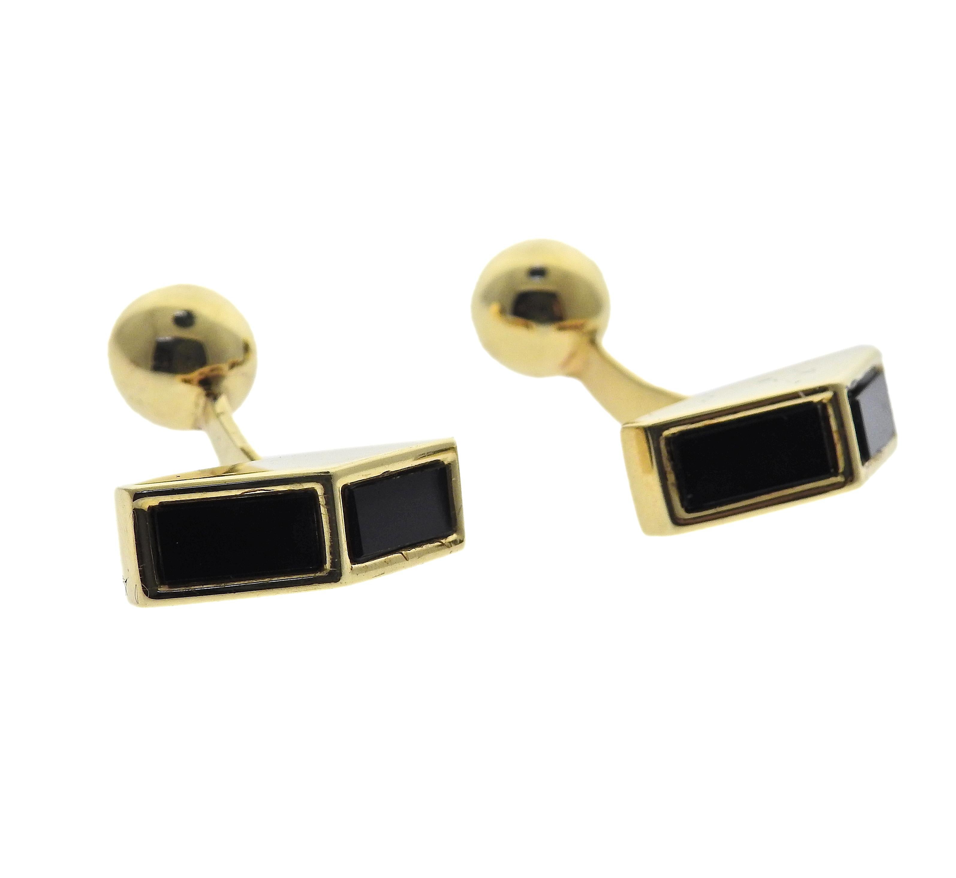 Vintage set of studs and cufflinks made by Tiffany & Co in 18K yellow gold and anyx. Cufflink top measures 19mm x 6mm, back is 8mm in diameter. Stud measures 12.0mm x 7.0mm. Marked: Tiffany & Co, 18k. Weight is 32.0 grams. One cufflink has a light