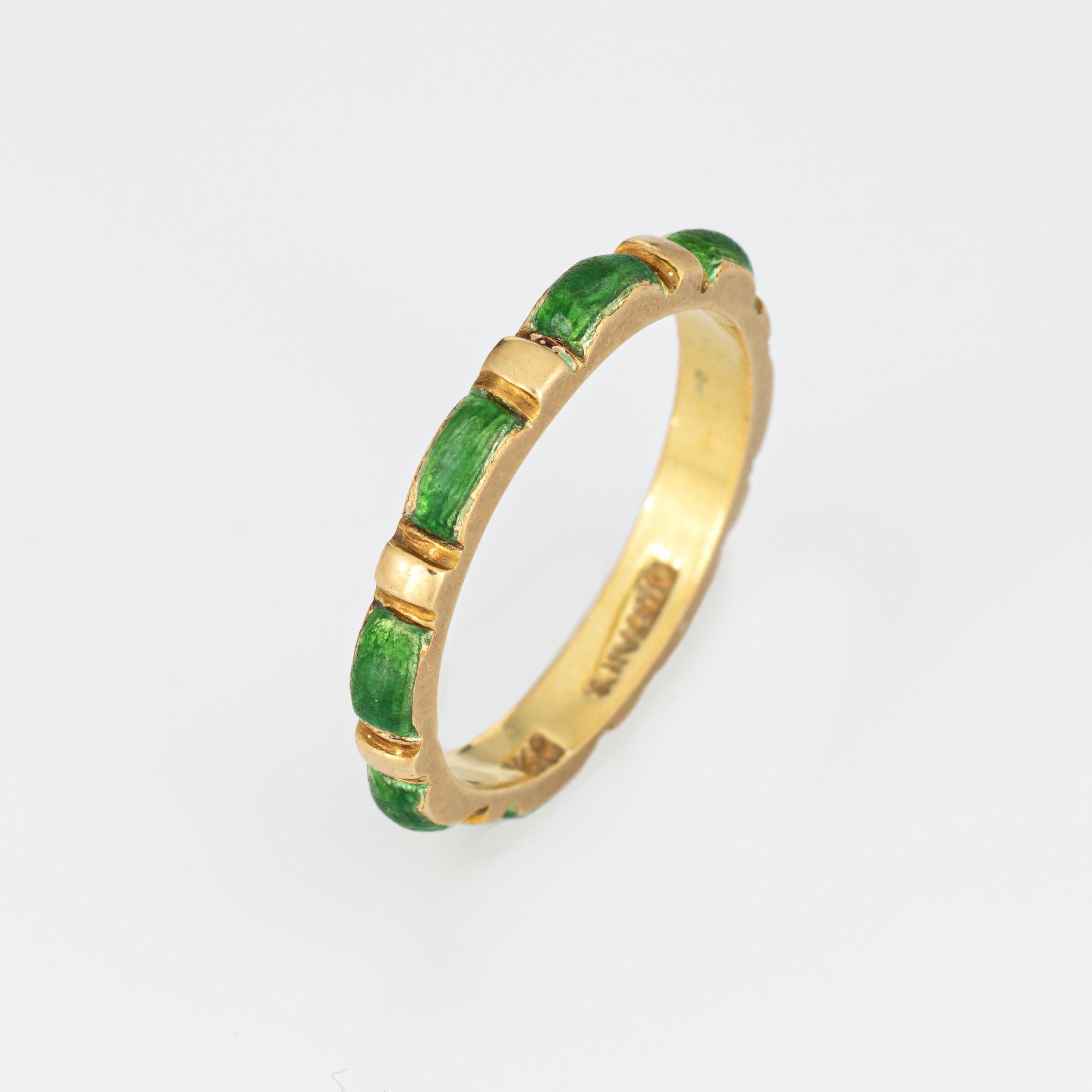 Vintage Tiffany & Co green enamel ring crafted in 18 karat yellow gold (circa 1970s to 1980s).  

Green enameled panels are continuous around the band for a seamless look. The enamel is in fair condition with enamel loss present. The slim 2.5mm wide