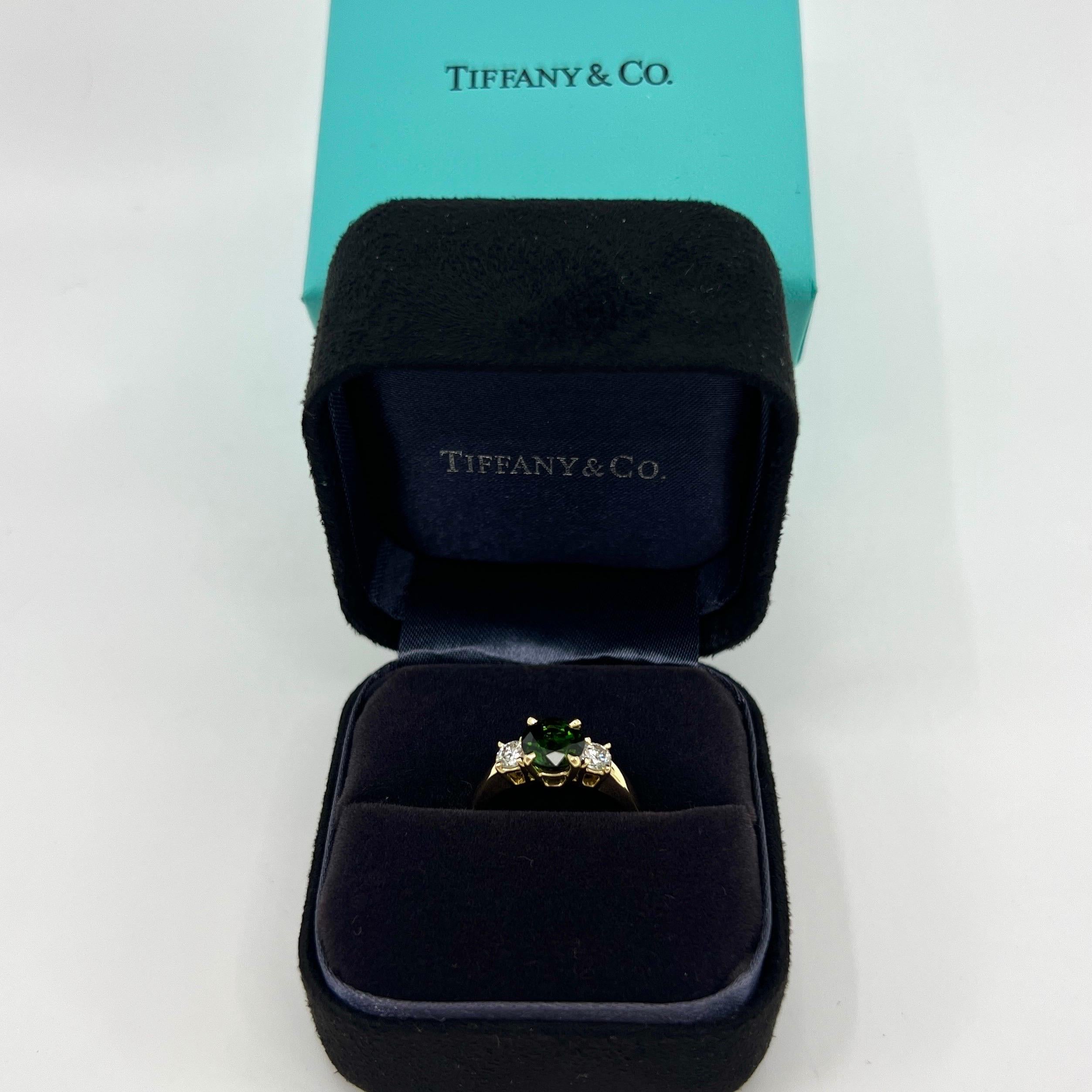 Vintage Tiffany & Co Round Cut Green Tourmaline And Diamond 18k Yellow Gold Three Stone Ring.

Fine jewellery houses like Tiffany only use the finest diamonds and gemstones in their jewellery and this piece is no exception. A top quality 6.5mm round