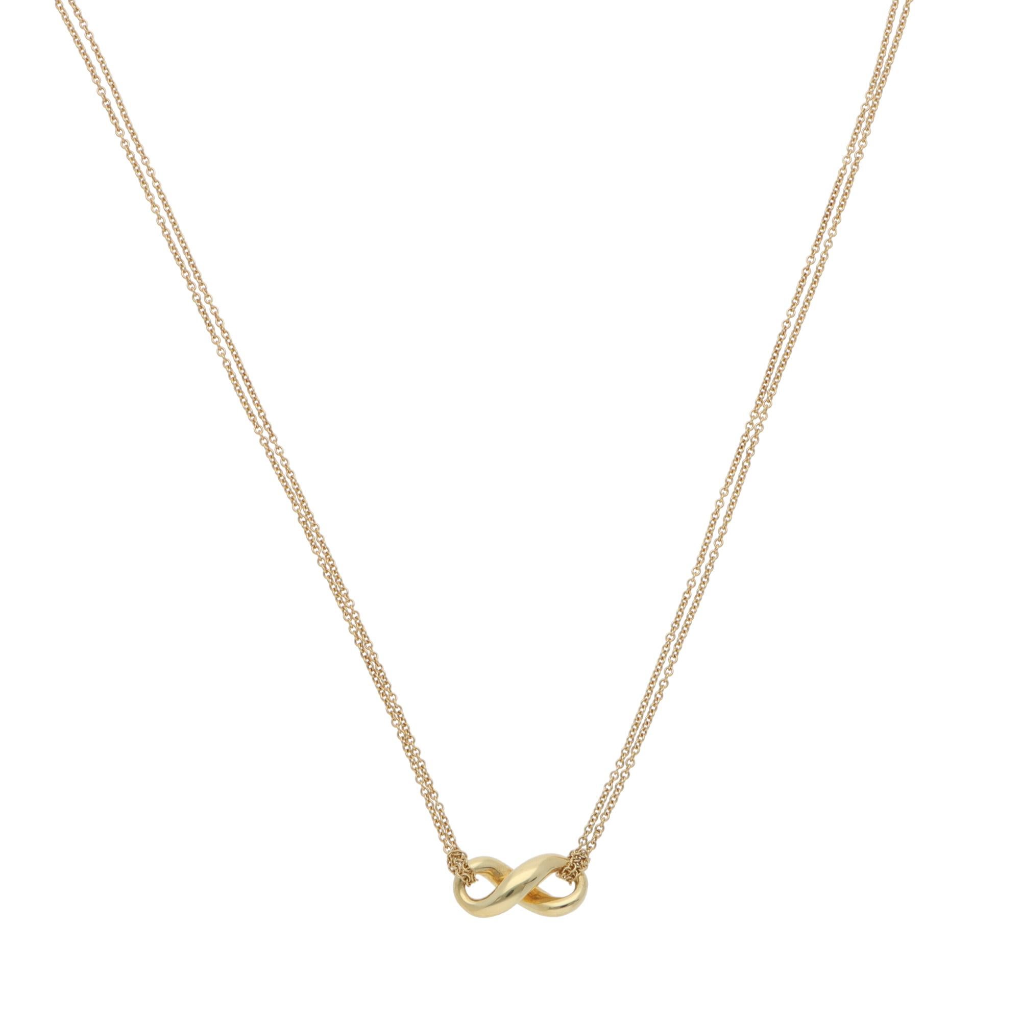 A beautiful vintage Tiffany & Co. Infinity pendant necklace in 18k yellow gold.

From the current Infinity collection, the pendant depicts a polished yellow-gold infinity motif. The pendant connects elegantly to a double-stranded trace chain, which