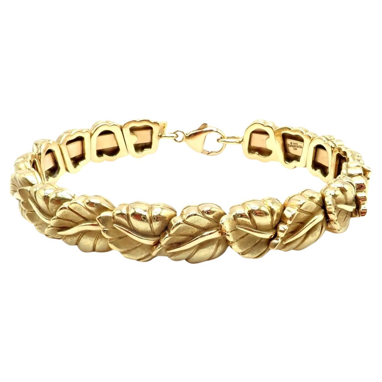 18k Yellow Gold Vintage Leaf Link Bangle Bracelet by Tiffany & Co. 
Vintage and authentic, this 2002 Tiffany & Co. link bracelet is crafted from luxurious 18k yellow gold. 
Featuring an elegant leaf motif in each link, it embodies timeless