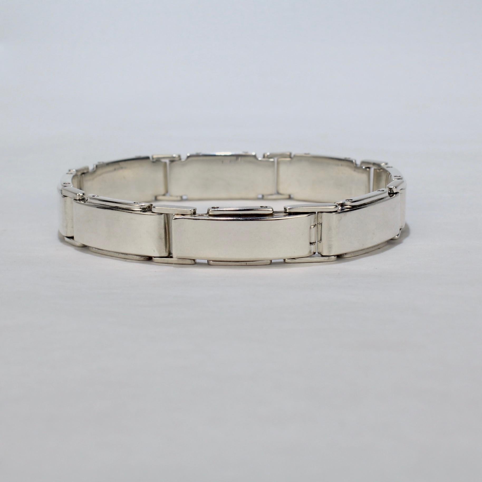 A vintage Tiffany & Co. bracelet.

In sterling silver. 

In the Metropolis pattern with Machine Age style slightly convex, rectangular link with faux rivets to their sides.

Simply a strong, masculine link bracelet by Tiffany!

Date:
Late 20th