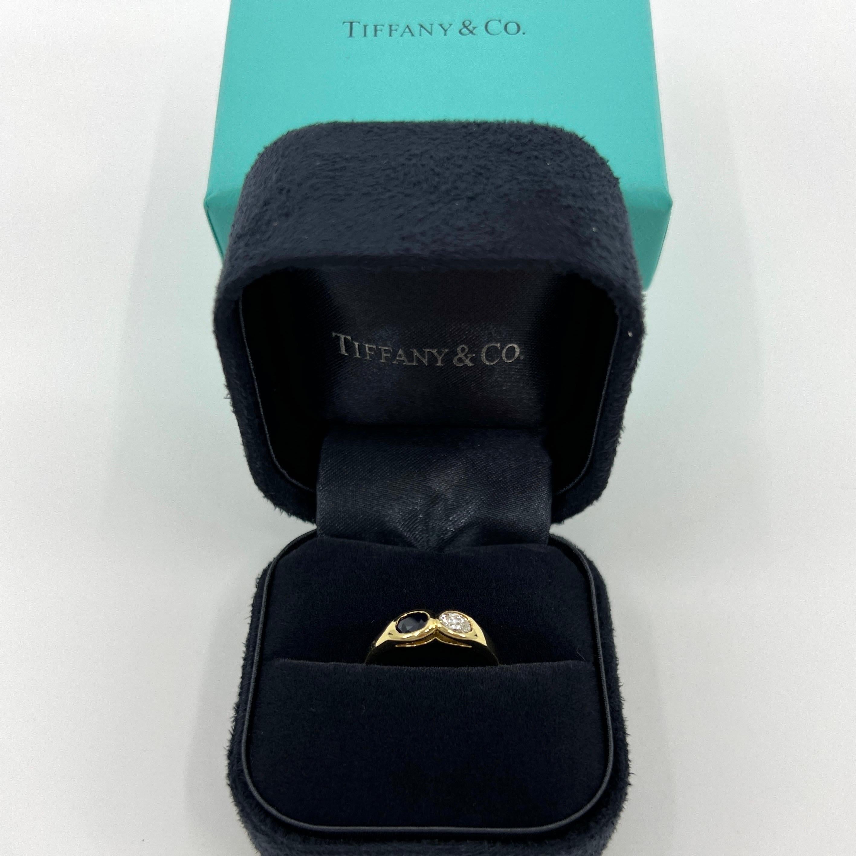 Rare Vintage Tiffany & Co. Oval Cut Blue Sapphire & Diamond 18k Yellow Gold Two Stone Ring.

A beautifully made yellow gold ring, bezel set with 2 stunning natural gemstones. A 5x3.5mm oval cut deep blue sapphire and a 5x3mm oval cut colourless