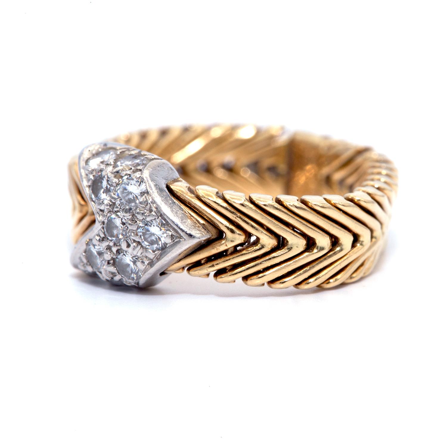This gold braided band was designed by Paloma Picasso for Tiffany & Co. in the 1980s.
Paloma Picasso for Tiffany 18-Karat Chevron Woven Gold Ring with Diamond Arrow
A design Classic by Paloma Picasso for Tiffany and Co. of a flexible 18-karat gold