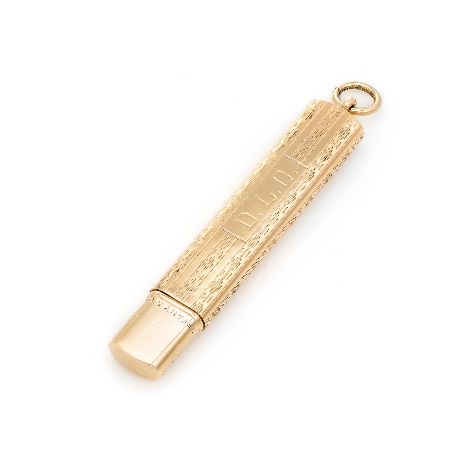Unique Tiffany & Co pendant or charm, crafted in 14 karat yellow gold.  

The outer case features a textured pattern with a cartouche engraved with the initials 