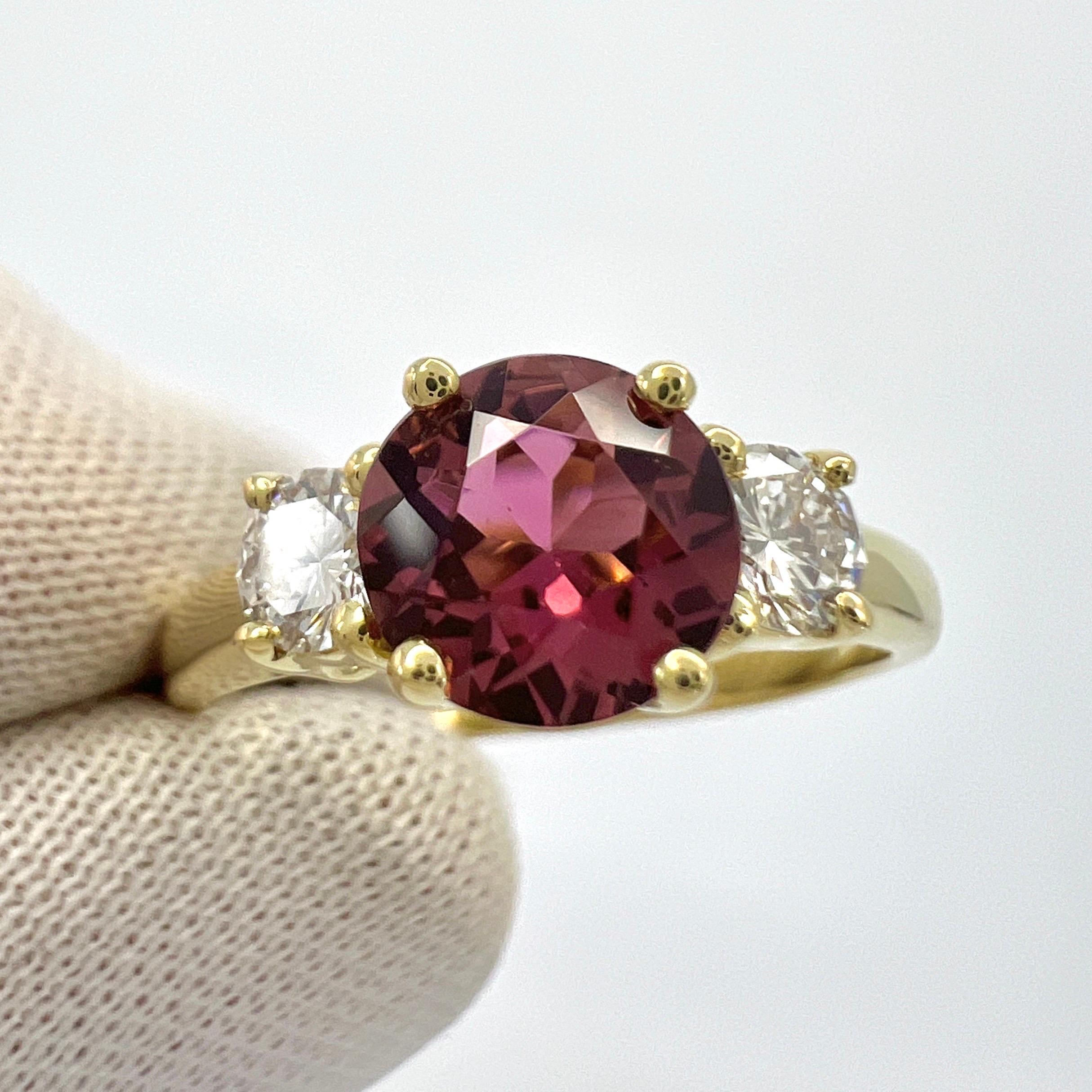 Vintage Tiffany & Co Round Cut Pink Tourmaline And Diamond 18k Yellow Gold Three Stone Ring.

This classic three stone ring features a top quality 6.5mm round cut deep pink tourmaline - approximately 1.30 carat. 
Accented by two 3.7mm natural
