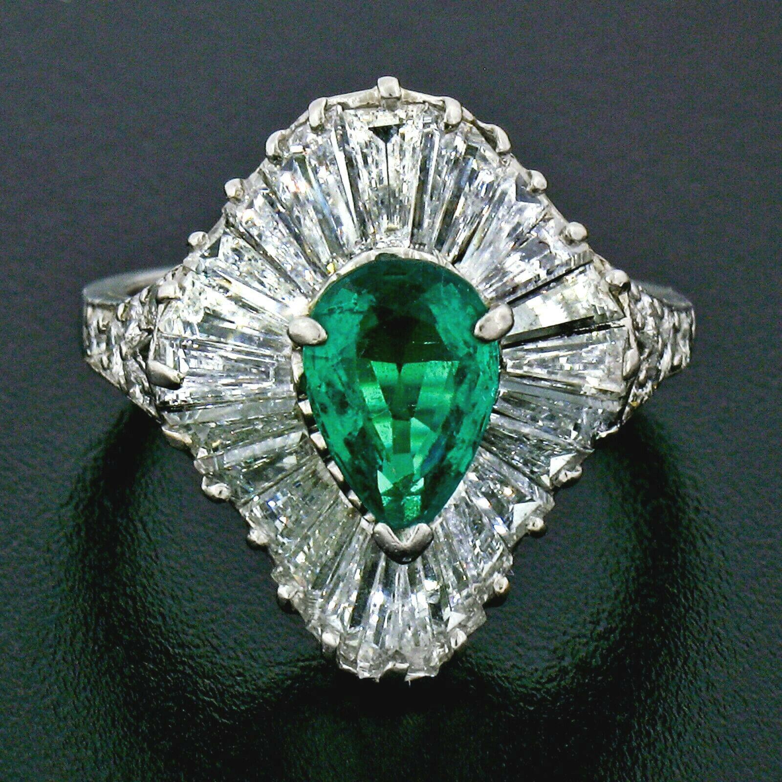 You are looking at a truly unique and breathtaking, AGL certified, genuine emerald and diamond ballerina ring designed and crafted by Tiffany & Co. in solid platinum. The ring features a pear cut, Colombian emerald solitaire with an outstandingly