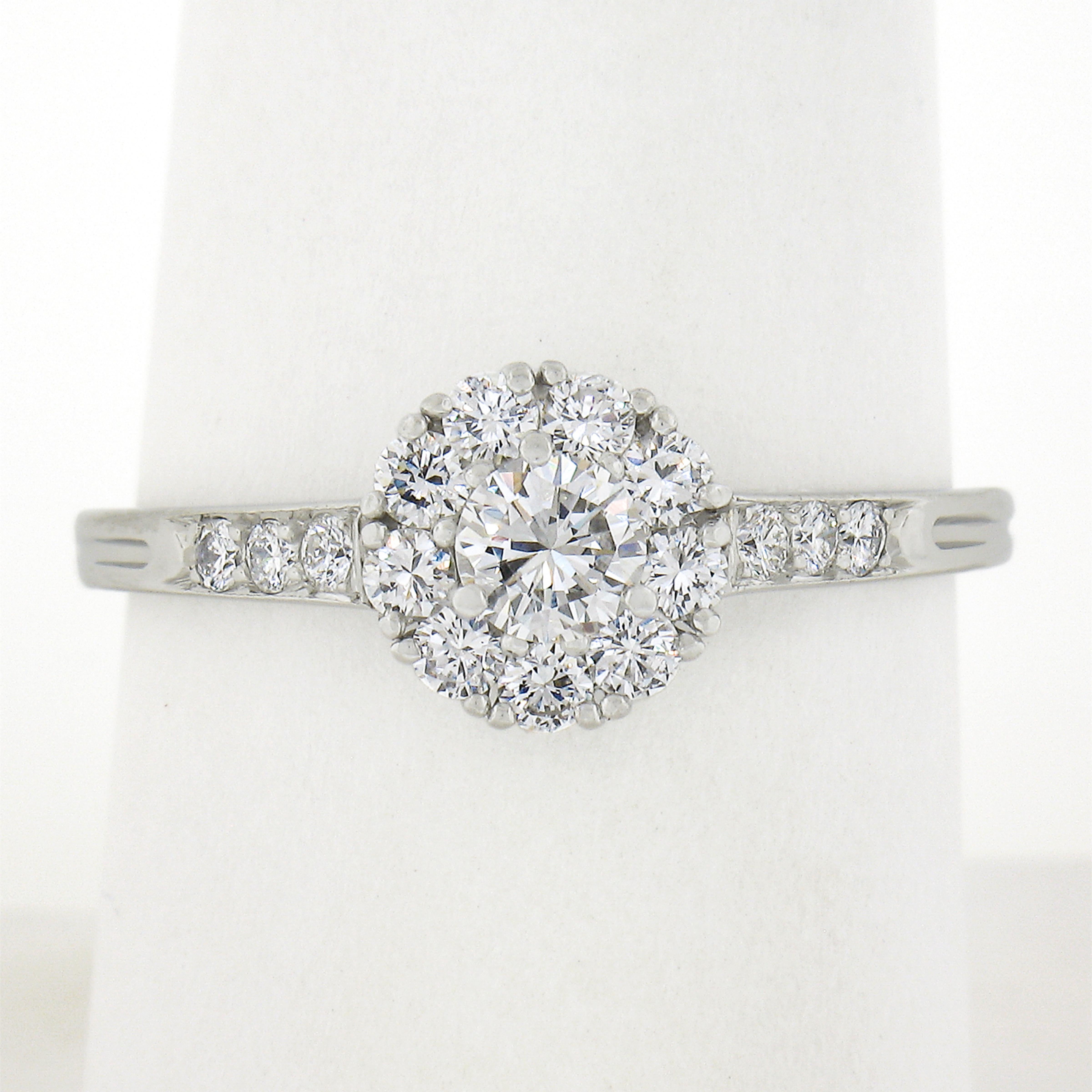 This beautiful vintage ring by Tiffany & Co. was crafted from solid platinum and features a fine diamond cluster at its center. A beautiful engagement or promise ring! Enjoy! 

--Stone(s):--
(1) Natural Genuine Diamond - Round Brilliant Cut -