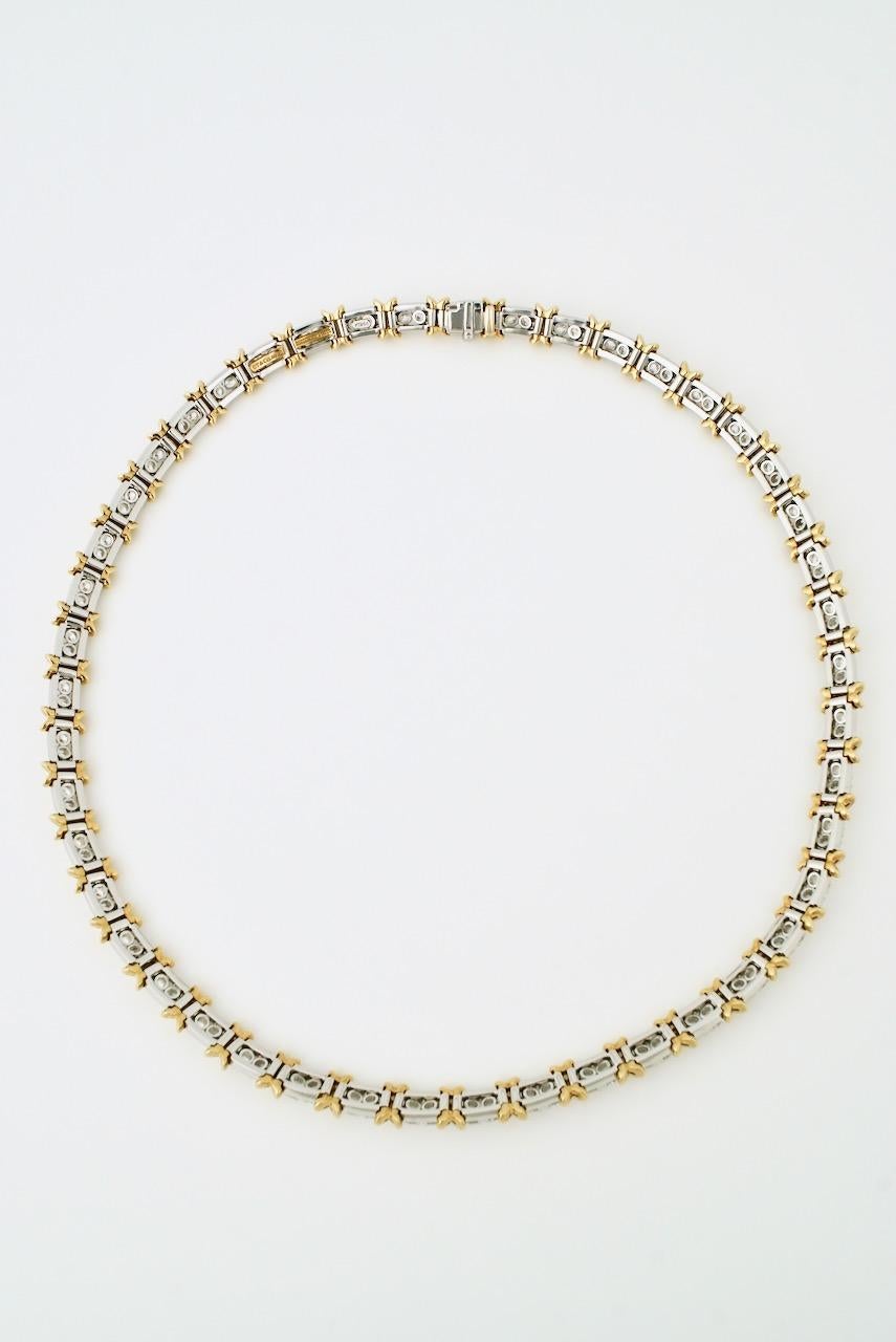 A vintage iconic kiss design necklace of 92 brilliant cut diamonds four claw set in platinum interspersed in pairs between 18k yellow gold 