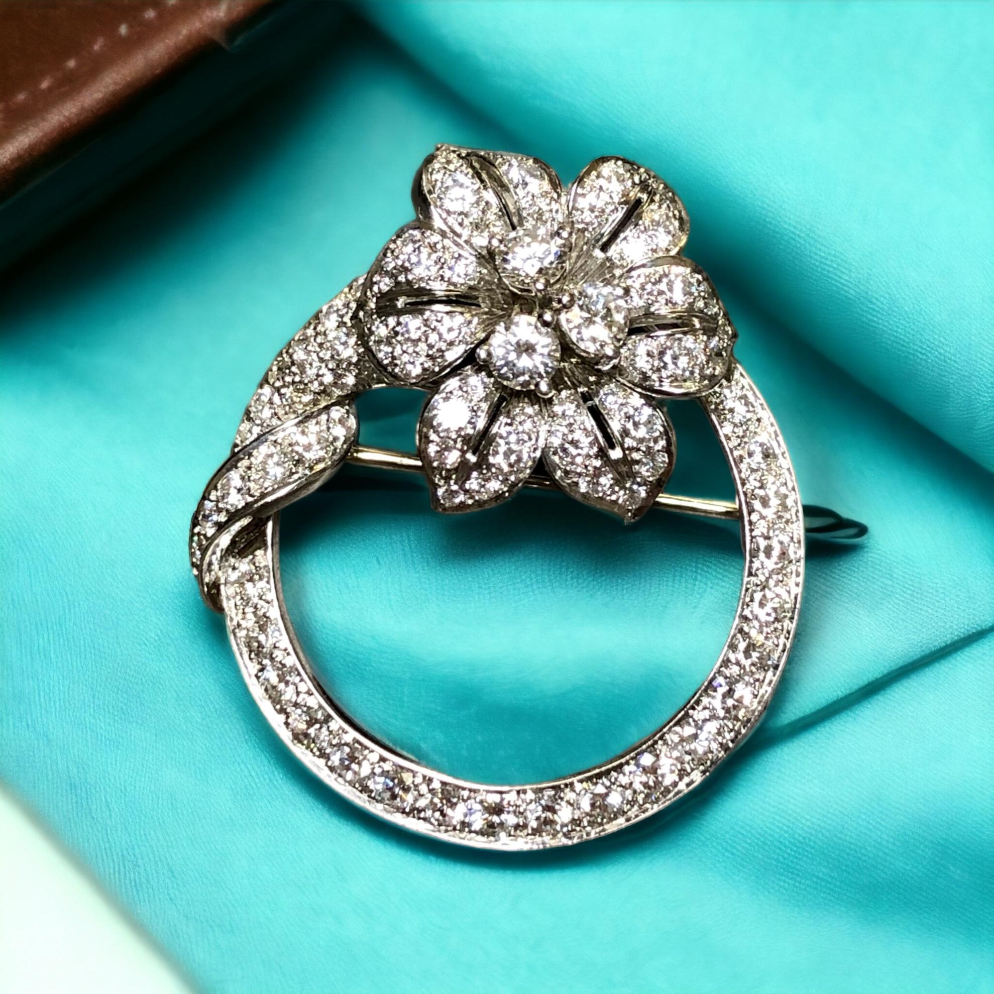 An original Tiffany & Co brooch c. 1960’s signed and numbered done in platinum and set with approximately 3.55cttw in F-G color Vs1+ clarity round diamonds. The work is exquisite as one would expect and the condition is absolutely perfect. This