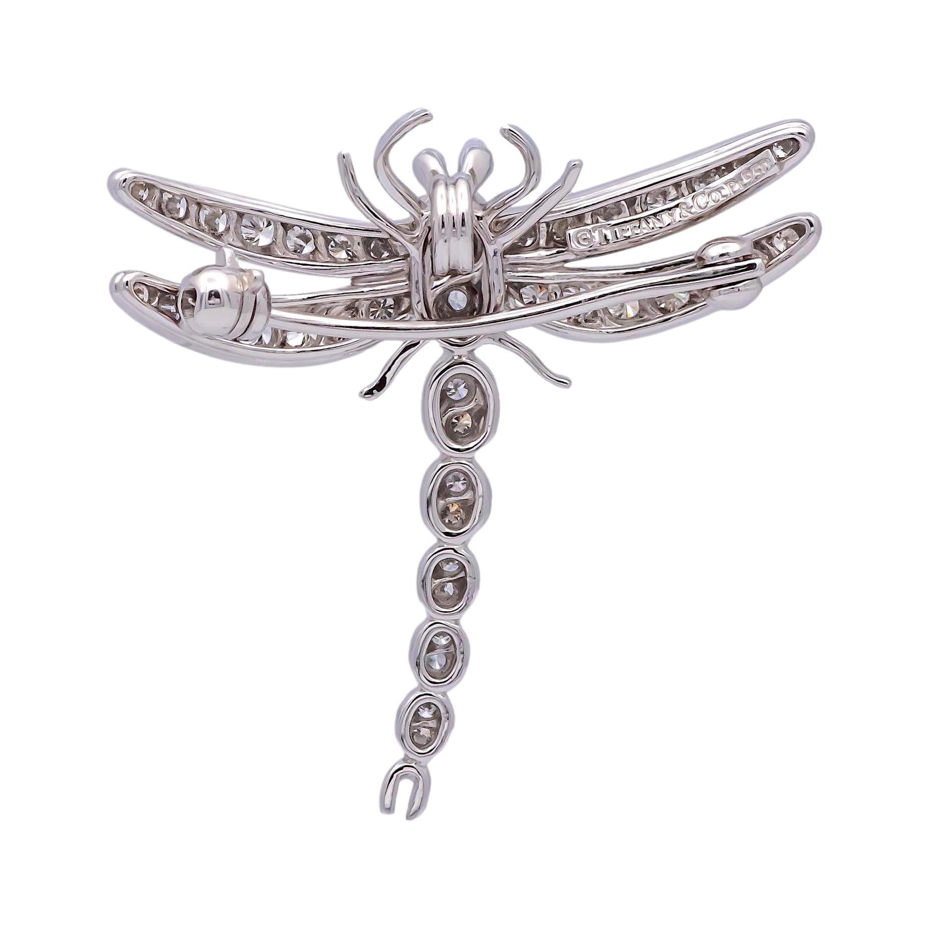 Vintage Tiffany & Co. brooch made around the 1990's finely crafted in platinum featuring prong set round brilliant cut diamonds weighing a total of .59 carats total weight approximately in a bright G color and fine VS1 quality. The dragonfly exudes