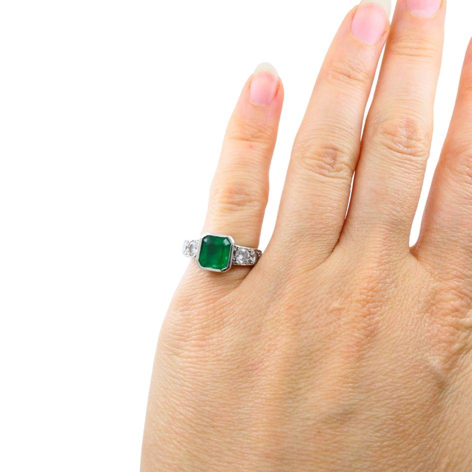 This vintage Tiffany & Co. ring is a beauty that would compliment any jewelry collection. Circa 1960s, this ring is made of platinum and is adorned with an Emerald in the center, that emerald is an emerald corner cut. The ring also has 4 diamonds, 2