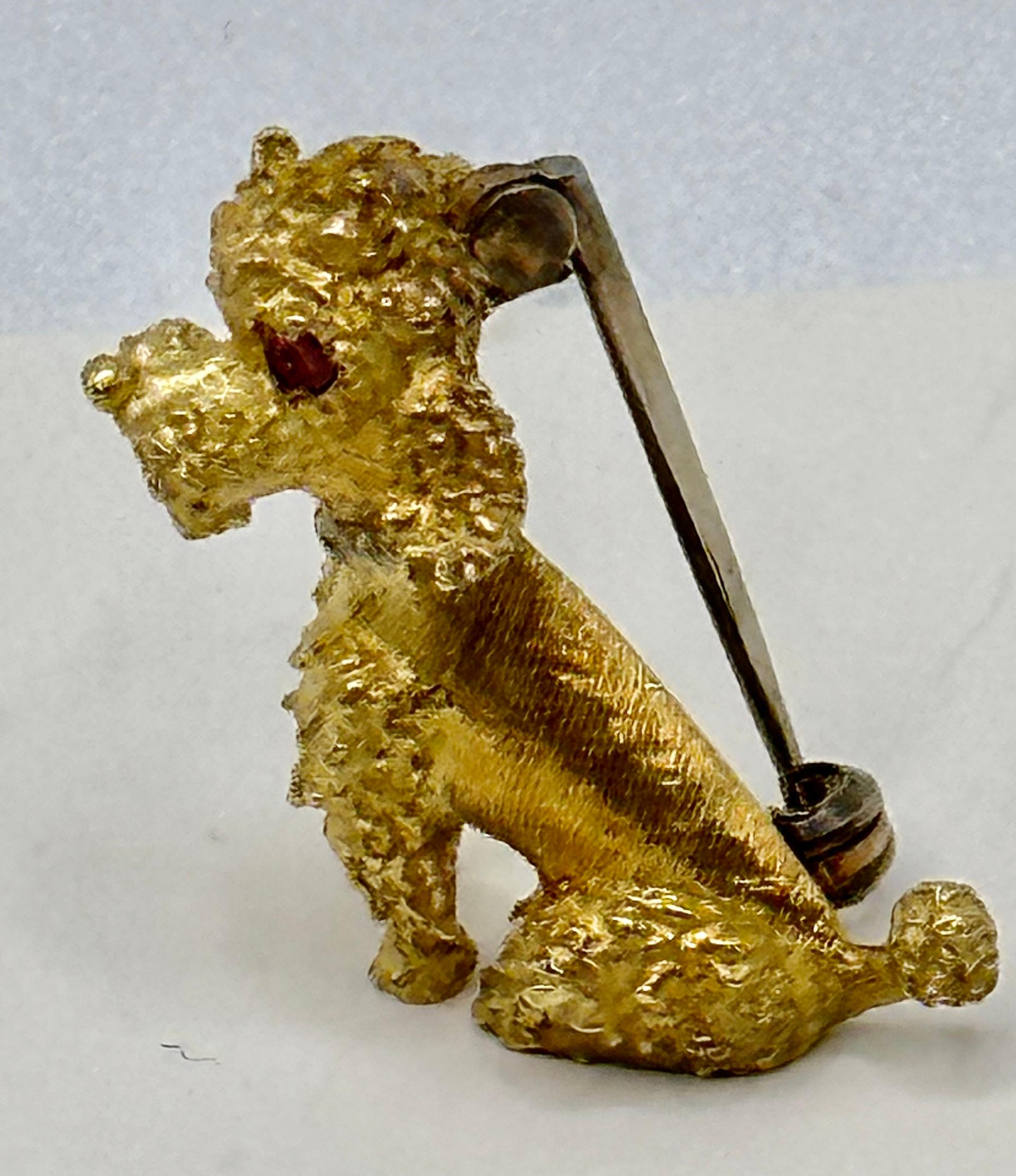 Vintage 1950s, Small but cute Tiffany &Co 18k yellow gold poodle brooch.
French poodle made in Italy with round  cabochon Ruby eyes.  
Stamped TIFFANY &Co on the backside.