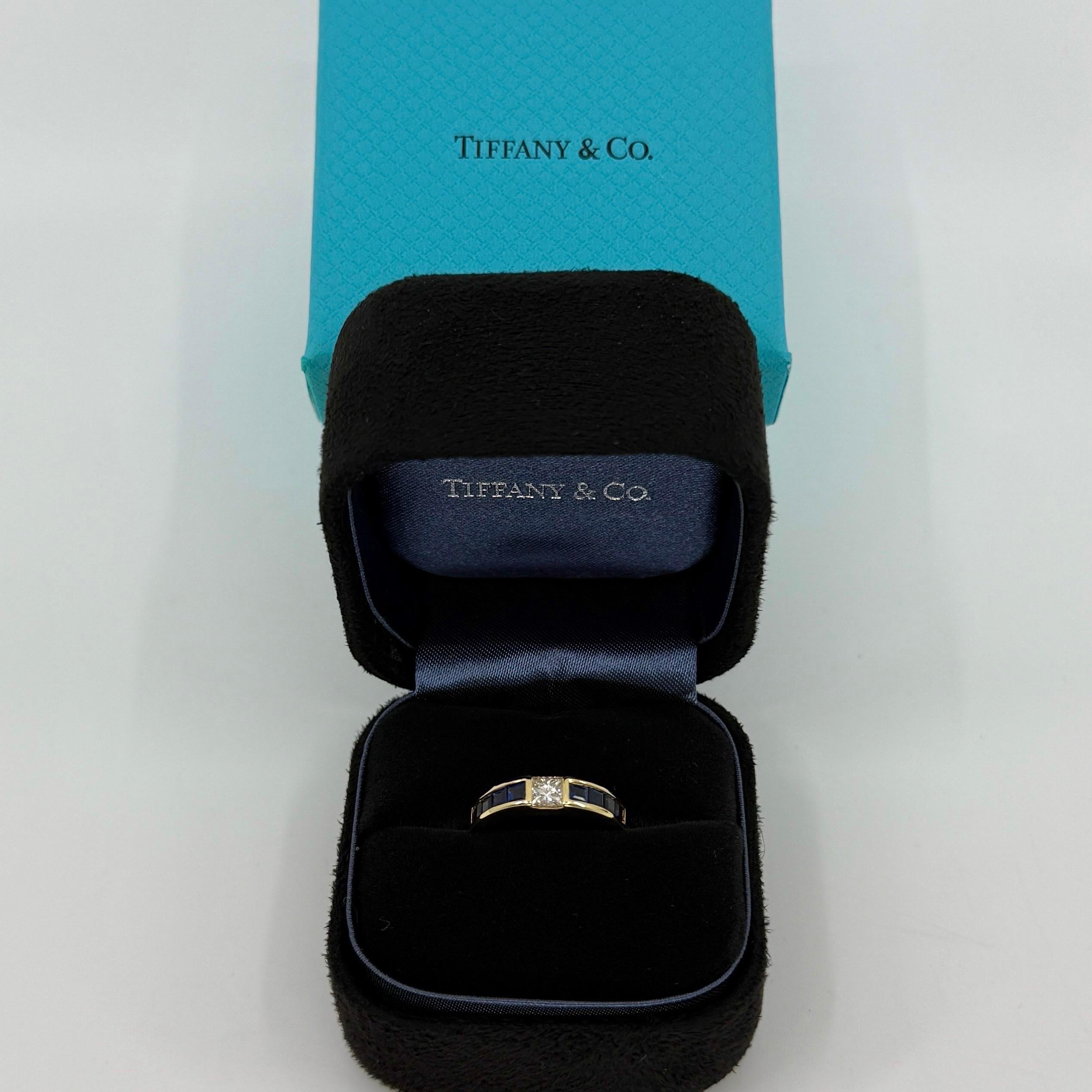 Vintage Tiffany & Co. Natural Princess Cut Diamond & Blue Sapphire 18k Yellow Gold Band Ring.

A beautifully made yellow gold band ring set with a stunning 3.75mm natural princess cut diamond centre stone. Band width measuring 3.75 mm and tapering