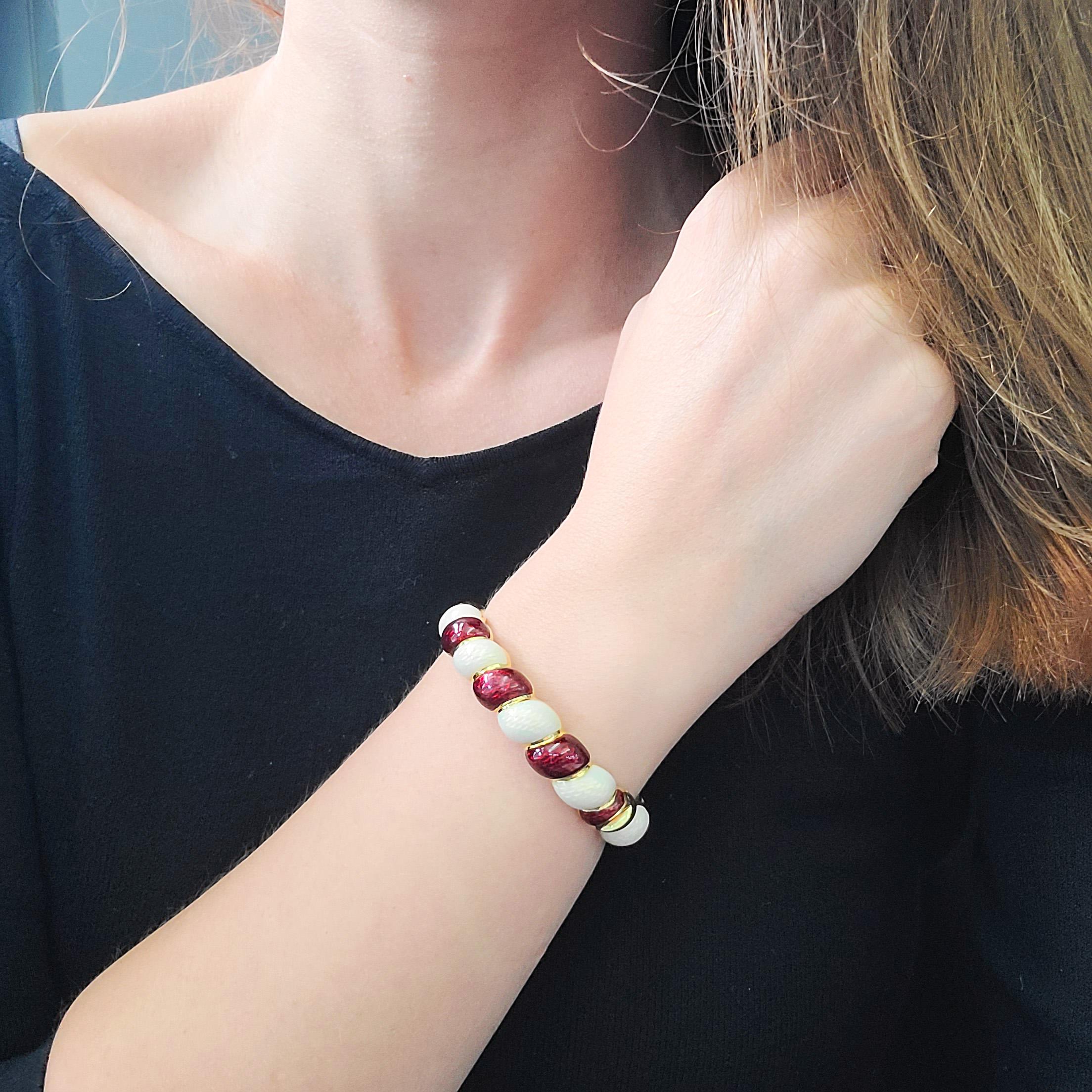 Vintage Tiffany & Co. Red and white enamel
bracelet crafted in 18K Yellow Gold. The bracelet features twist design, alternating white and red enamel covered strands. Equipped with the hinge, box clasp, and safety chain Inscribed: Tiffany & Co, 18k,