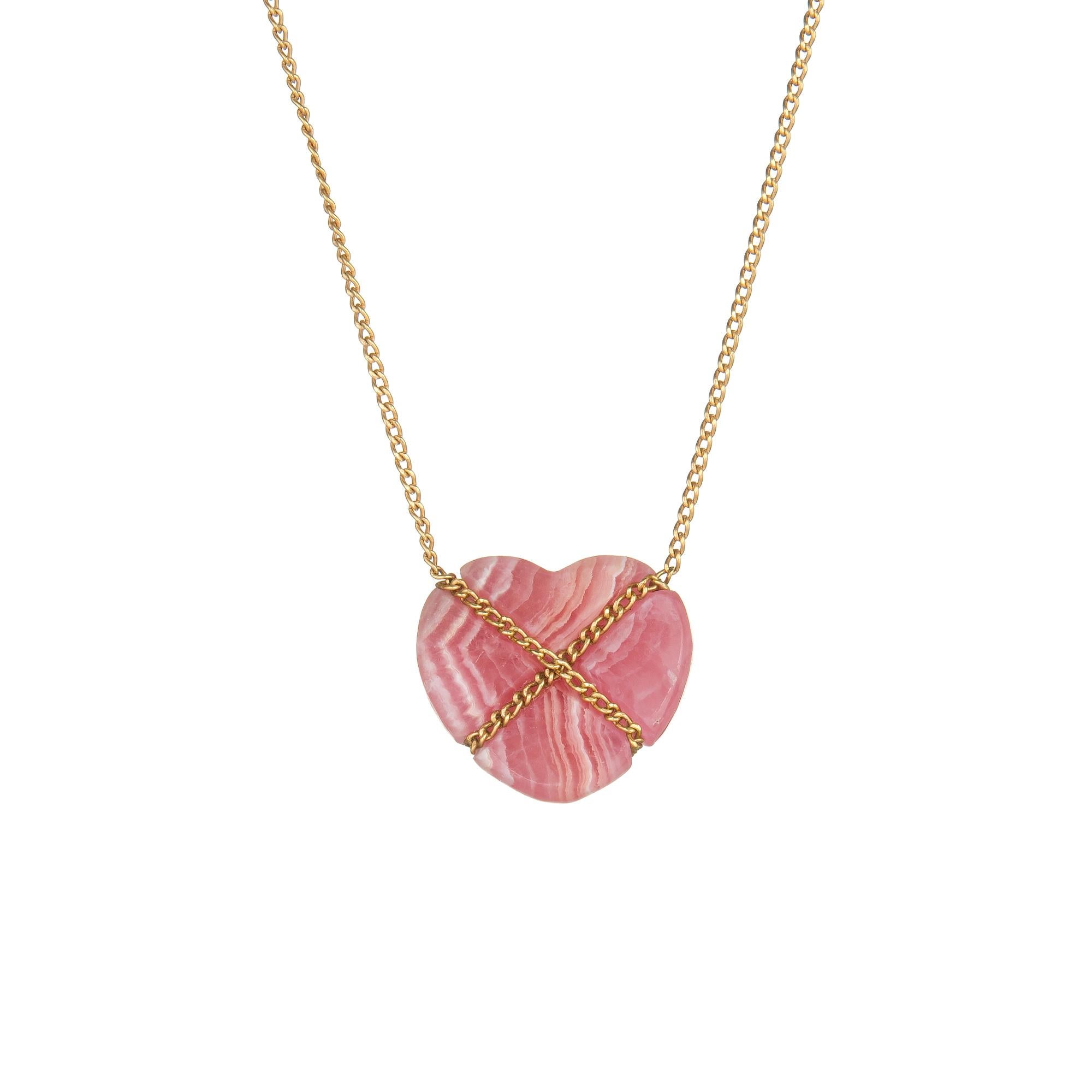 Elegant and finely detailed vintage Tiffany & Co rhodochrosite Cross My Heart necklace, crafted in 18 karat yellow gold.  

Rhodochrosite is set into the necklace and measures 14mm x 13mm. The stone is in excellent condition and free of cracks or
