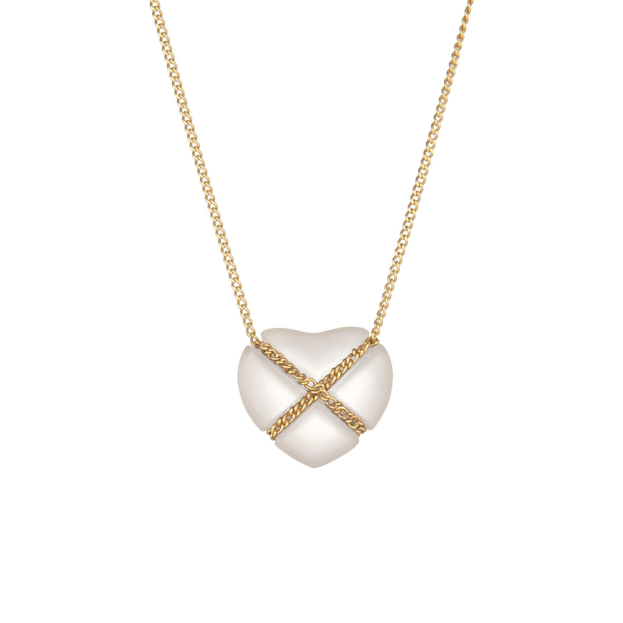 Elegant and finely detailed vintage Tiffany & Co rock crystal Cross My Heart necklace, crafted in 18 karat yellow gold. 

Rock crystal is set into the necklace and measures 14mm x 13mm. The stone is in excellent condition and free of cracks or