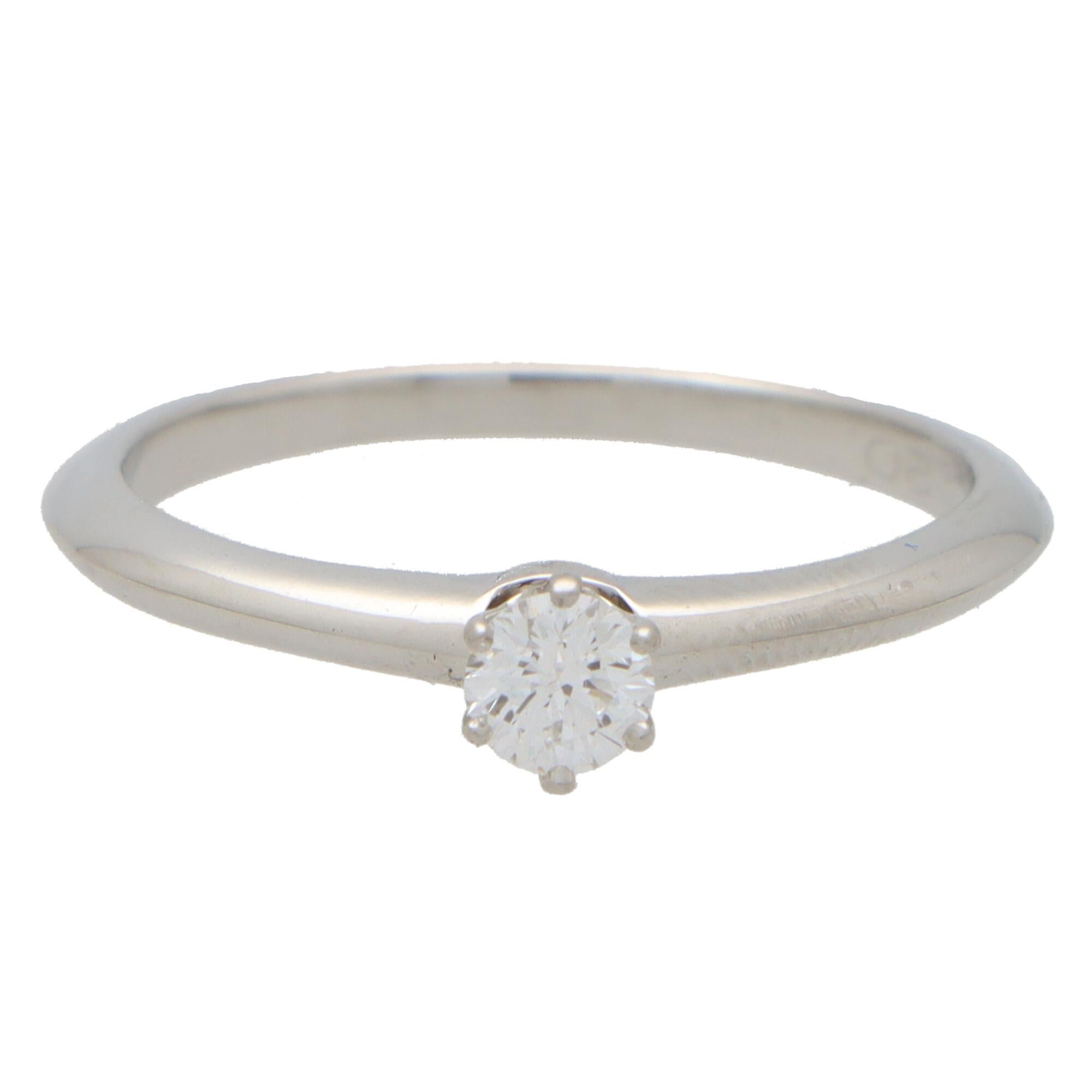 A beautiful vintage Tiffany & Co. round brilliant cut diamond single solitaire ring, set in platinum.

The piece is solely set with a beautiful 0.20 carat round brilliant cut diamond which is six-claw set in a knife edge band mounting.

The beauty