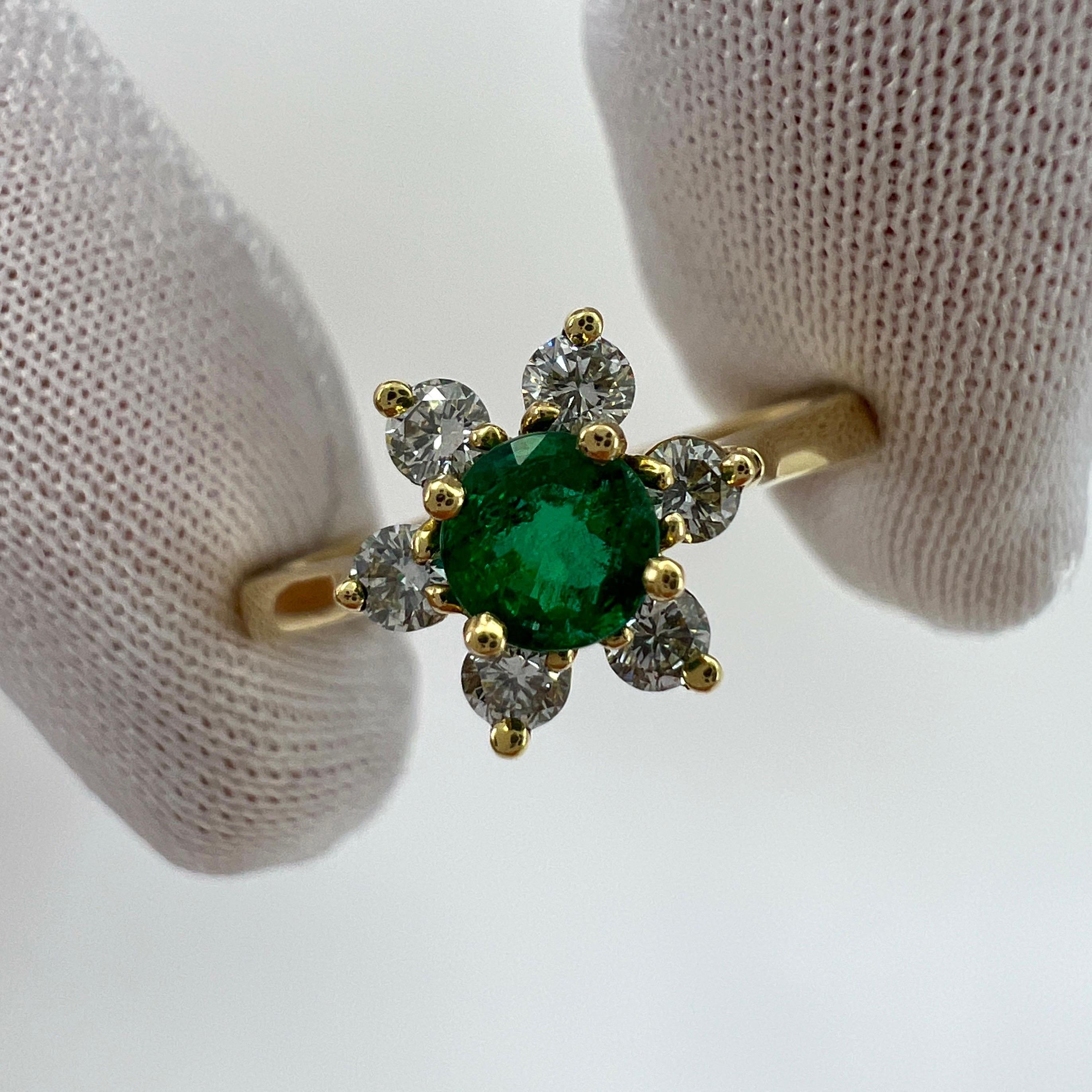 Vintage Tiffany & Co. Natural Round Emerald And Diamond 18k Yellow Gold Flower 'Buttercup' Ring.

A beautifully made yellow gold cluster ring set with a stunning 4.1mm round cut natural emerald centre stone. Superb colour with very good clarity and